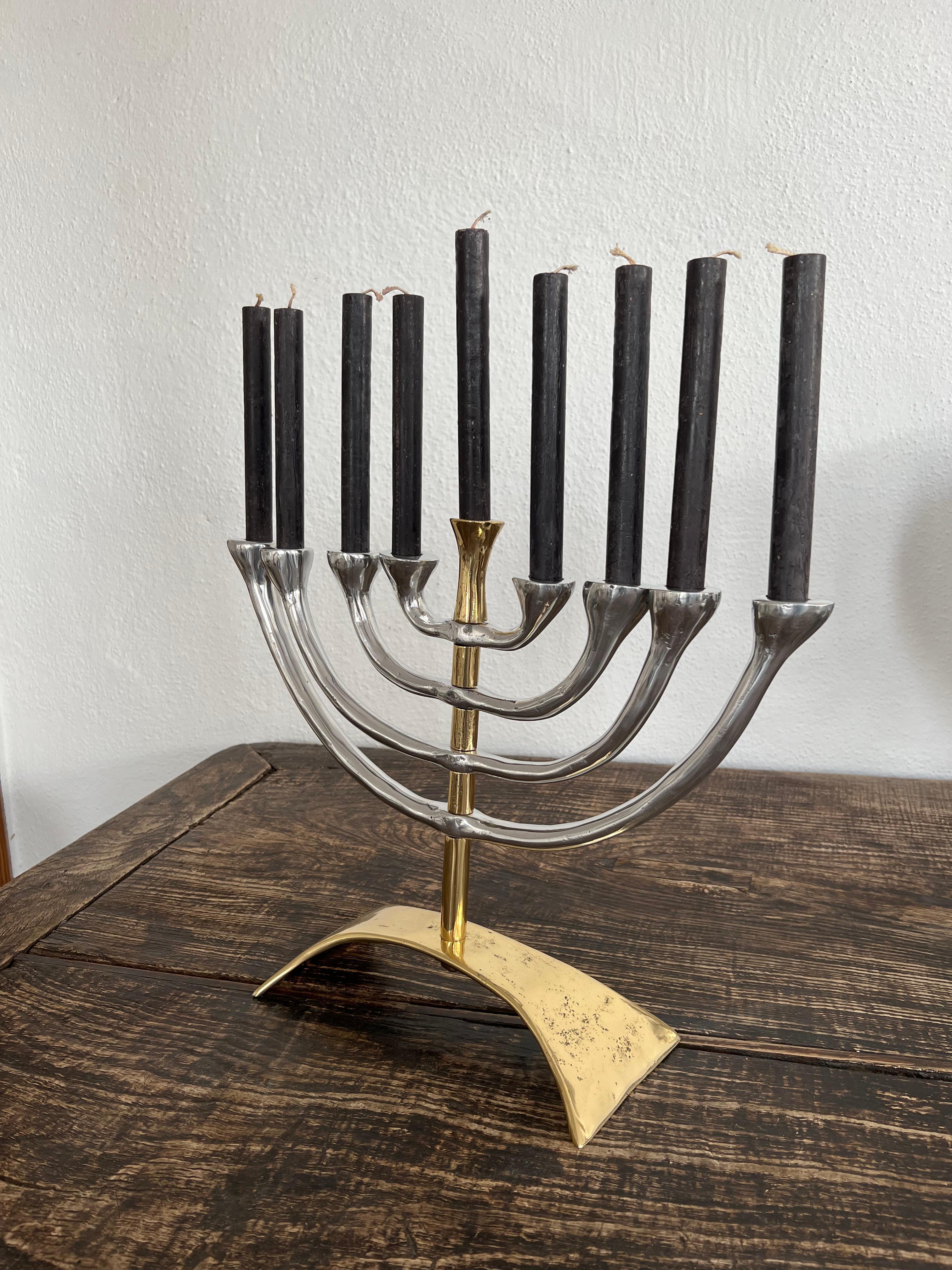 The decorative Menorah was created by David Marshall, it is made of sand cast aluminum and sand cast brass.
Handmade, mounted and finished in our foundry and workshop in Spain from recycled materials.
Certified authentic by the Artist David