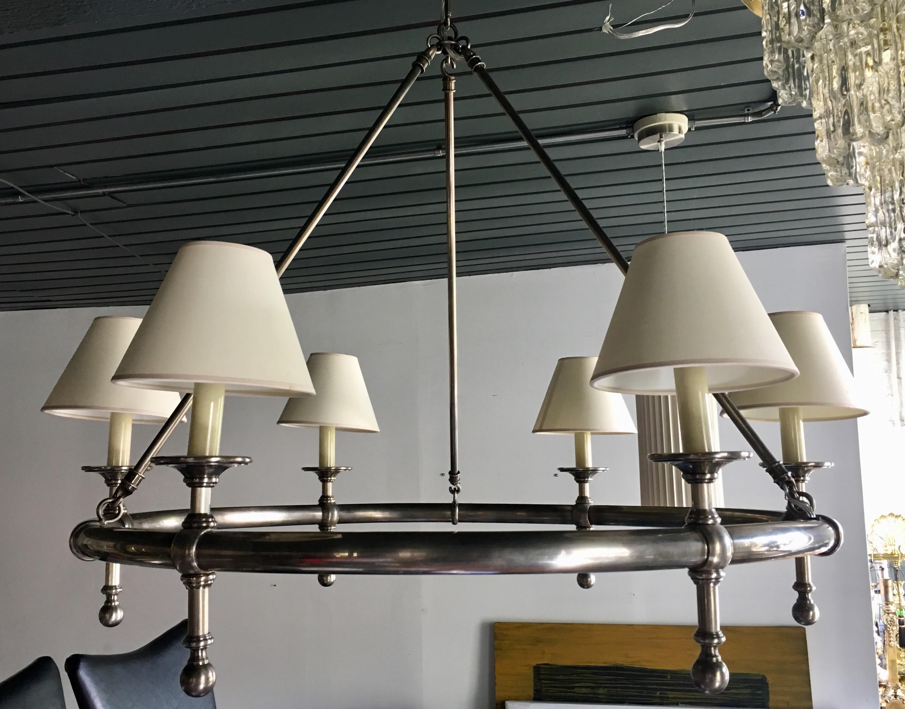 Classic antique nickel tubular ring chandelier light by Chapman. This traditional round 6-light ceiling fixture features an aged silver metal finish and cream paper shades. Candle base bulbs. 40 Watts per socket. 

Includes canopy and one chain