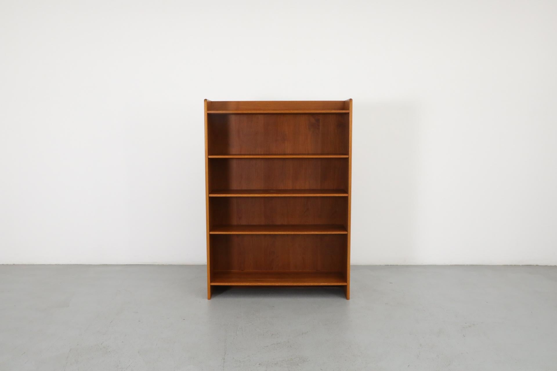 Two classic Mid-Century Danish teak bookcases. These stand alone units consist of 5 shelf tall bookcases. Shown with matching cabinets, listed separately (please inquire). Bookcases can stack perfectly on top of cabinets. One cabinet (A) has wood