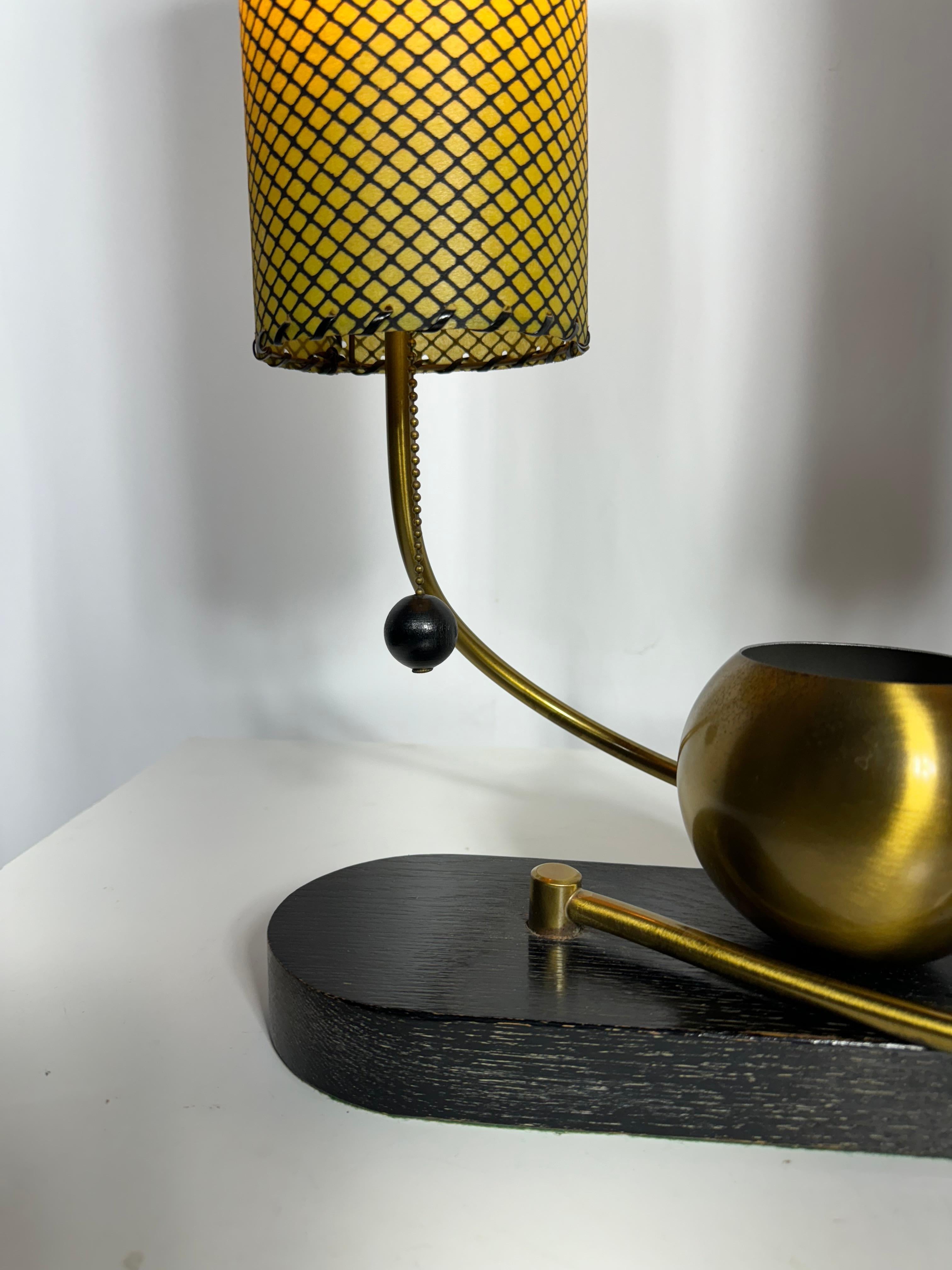 Classic Mid Century Double Shade Desk/Table Lamp by Majestic Lamp Co.. Swinging brass arms,, fully adjustable,,enabling several different configurations.Hanging wood balls on/off switch. Shades measure 12.5H x 4.5 in diameter,, Wonderful original