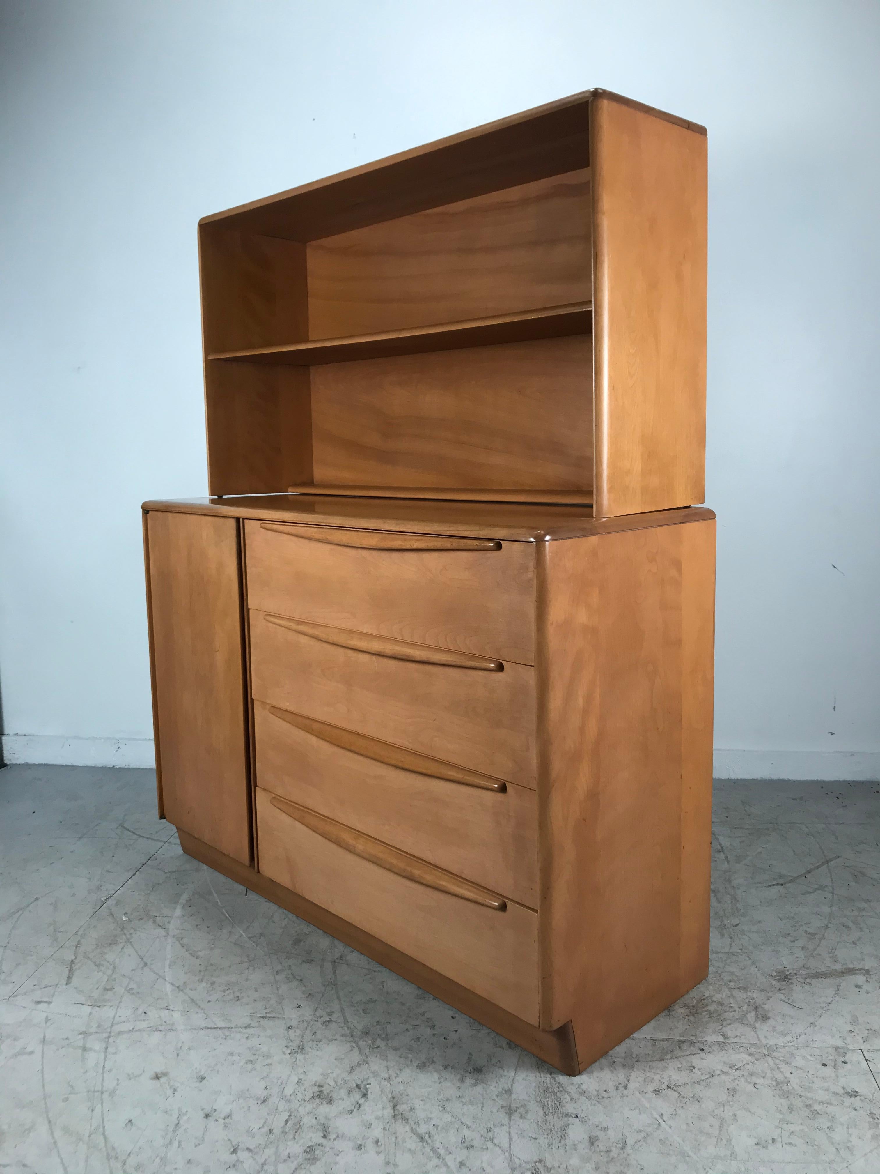 Classic Mid-Century Modern dresser/desk/ bookcase and chair. Very unusual case piece manufactured by Heywood Wakefield Furniture Company, multifunctional design. Bottom piece, left door with storage, shelves, right, 4 generous size drawers, top