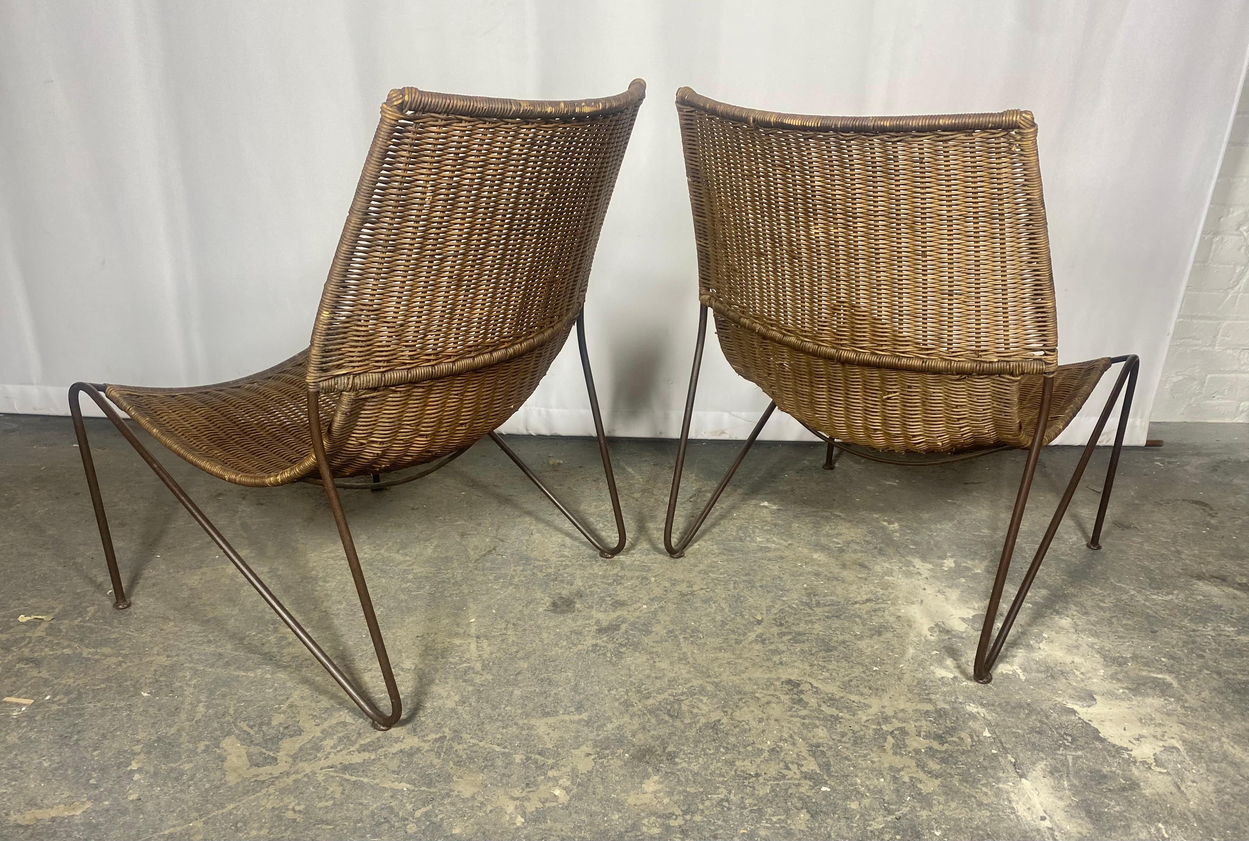Classic Pair of Mid Century Modern Iron and Wicker Sling , lounge chairs ., Often attributed to Frederic Weinberg, manner of Maurizio Tempestini for Salterini . Wonderful original condition,, Extremely comfortable,, Strong , sturdy,, Hand Delivery