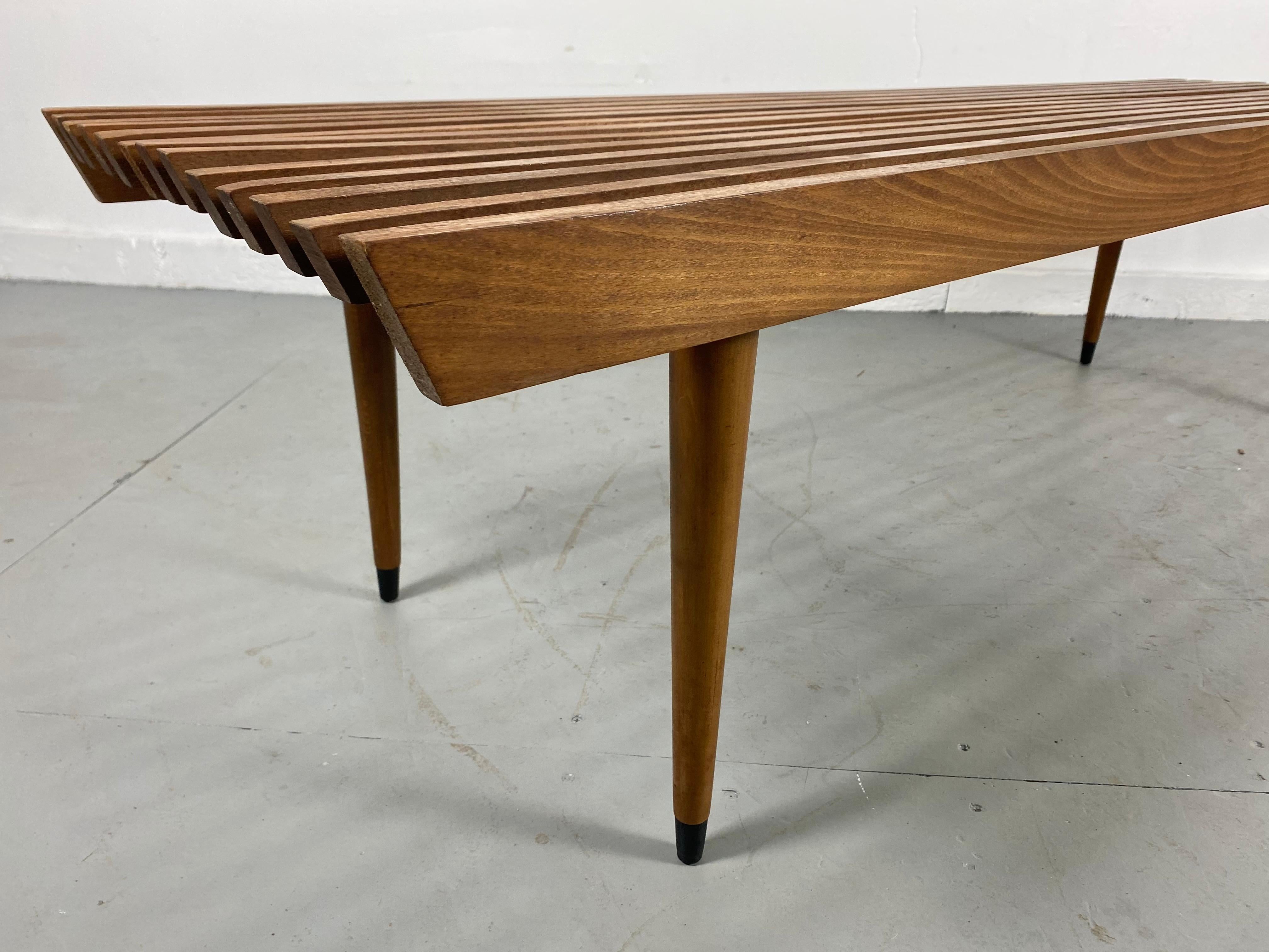 Classic Mid-Century Modern slat bench / table with tapered legs, 1960's, most likely Italian or Yugoslavian? wonderful grained walnut, nice original condition, patina, slight warping to a couple of wooden slats (see photo) hardly noticeable.