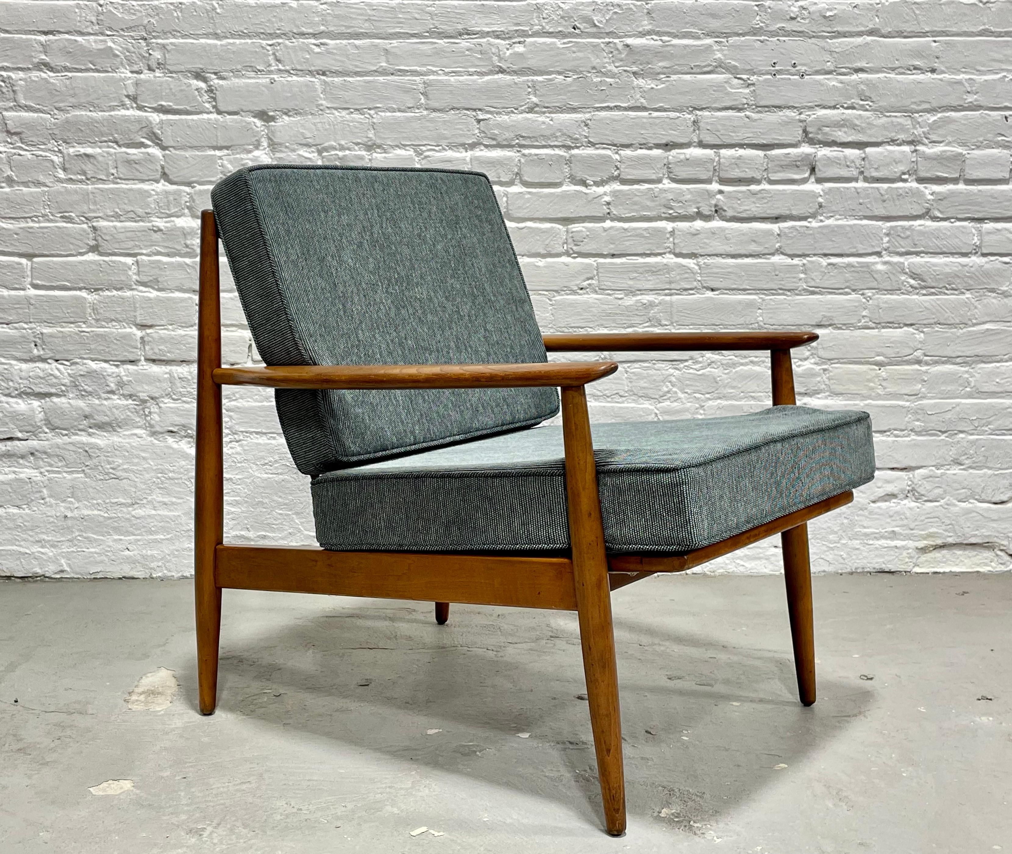 Classic Mid Century Modern Lounge Chair by Baumritter, circa 1960's. Great design with spindles along the back and solid flared arms. The upholstery and foam are both brand new and the color is a lovely sea blue that matches well with everything. 