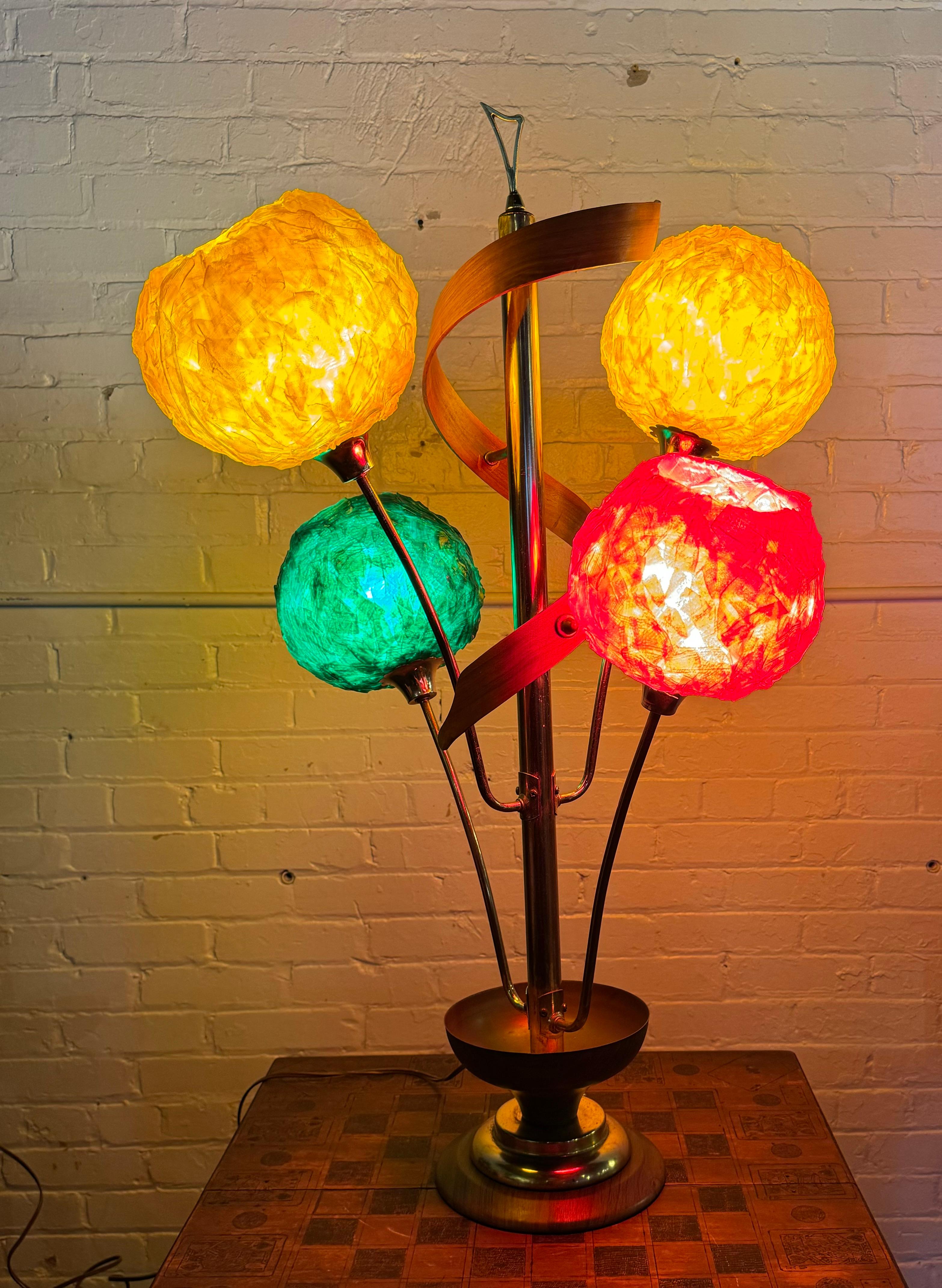  Four-light table lamp with stylized organic petal base, and spaghetti Lucite ball shades. Each light can be lit individually, or simultaneously. Classic over the top Mid-Century Modern design, Amazing original condition. no breaks, cracks , burns