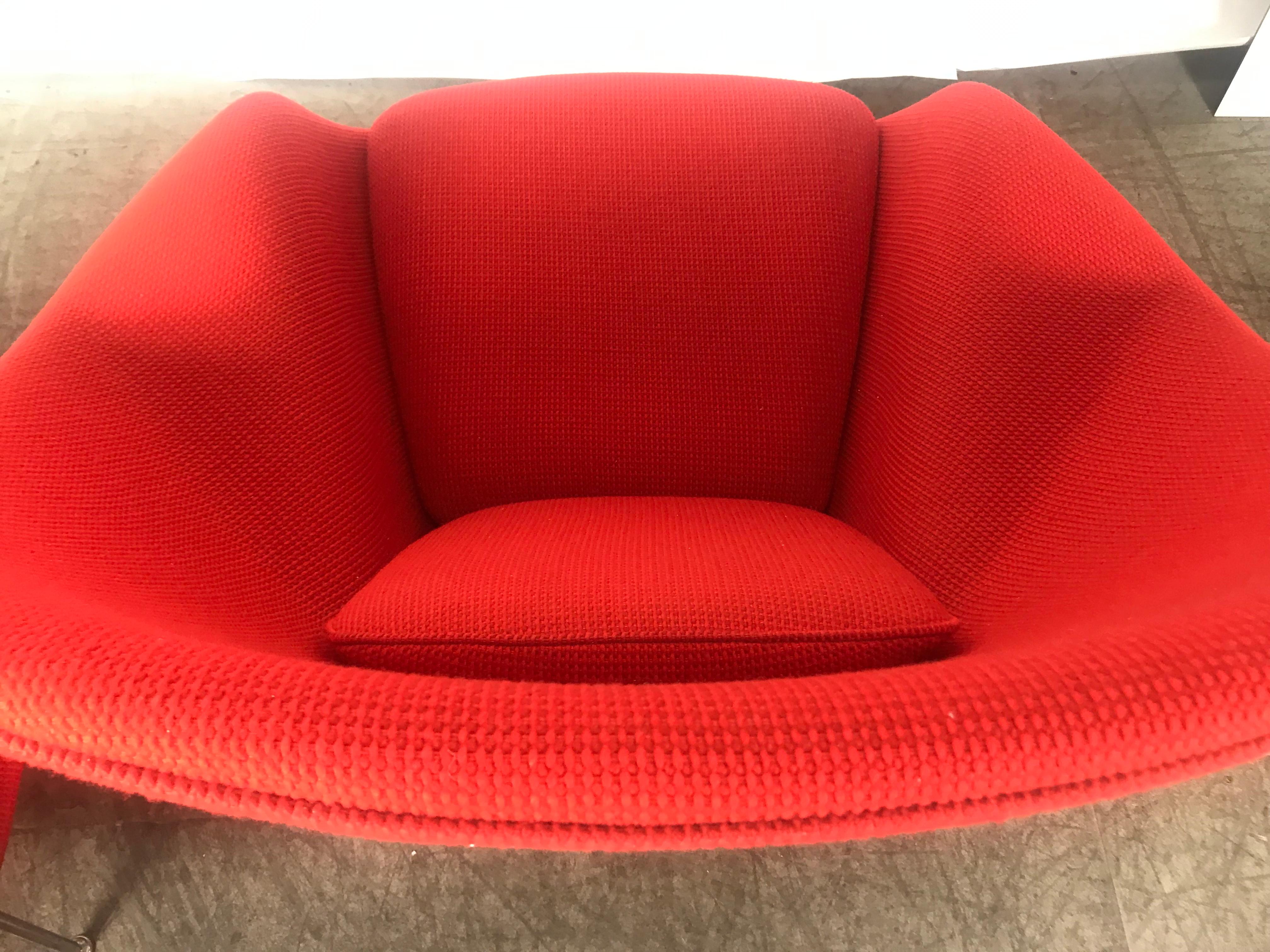 Iconic and Classic. this sculpturally designed Womb chair and accompanying ottoman is designed by famed Finnish ,American designer Eero Saarinen and produced by Knoll. The chair and ottoman retain their original red Crimson fabric. Amazing original