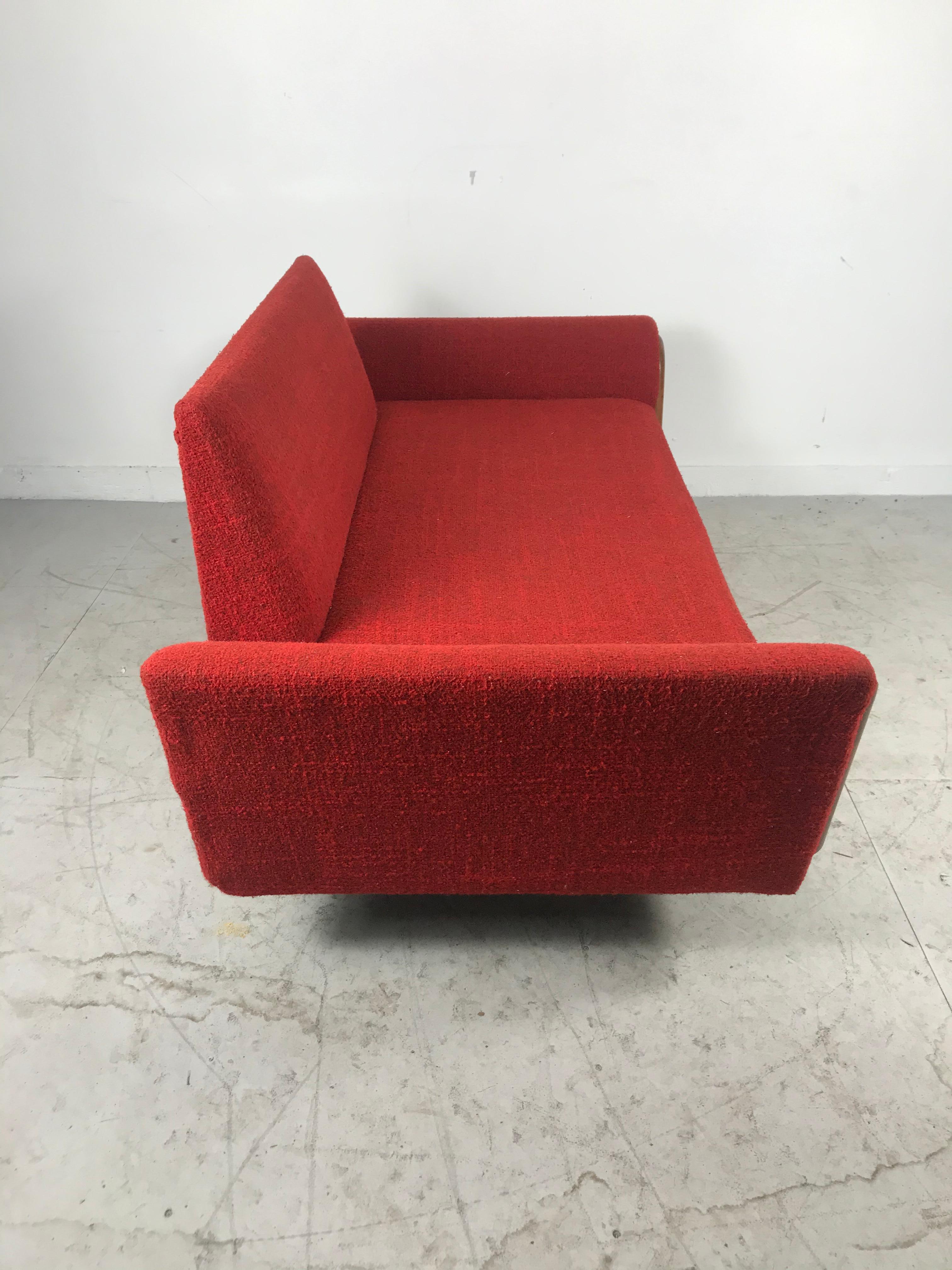 Classic modernist 2-seat sofa (loveseat), sculpted walnut detailing, original fire engine red wool upholstery in nice original condition. Attributed to Adrian Pearsall. Amazing design, Classic Mid-Century Modern.