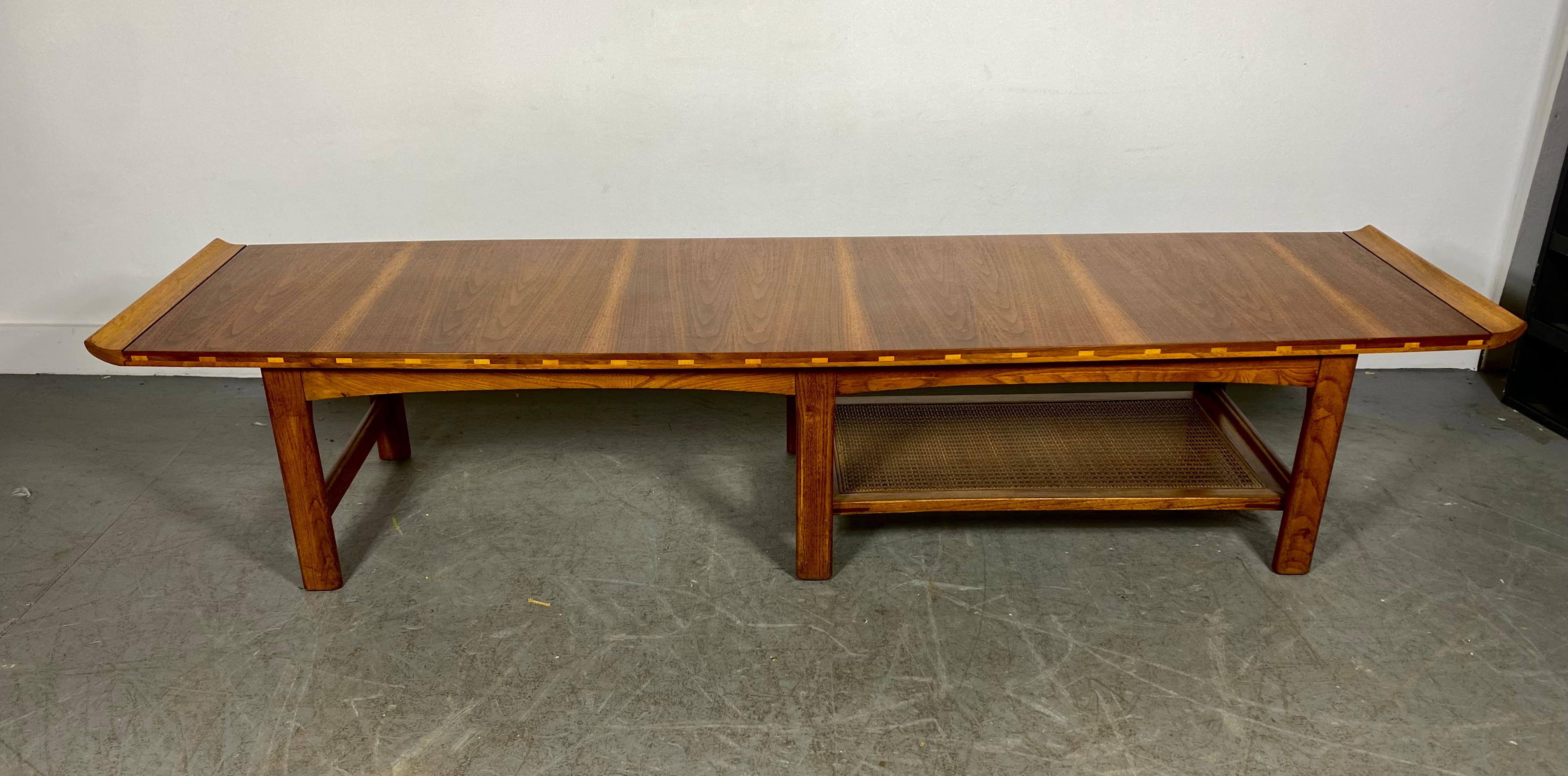  Classic Modernist, Mid Century Coffee / Cocktail table (long-john) Amazing Figured Walnut with birch or maple dove-tail detail edge and basket weave lower shelf. 
 Wonderful design..curved edges,Hand delivery avail to New York City or anywhere en