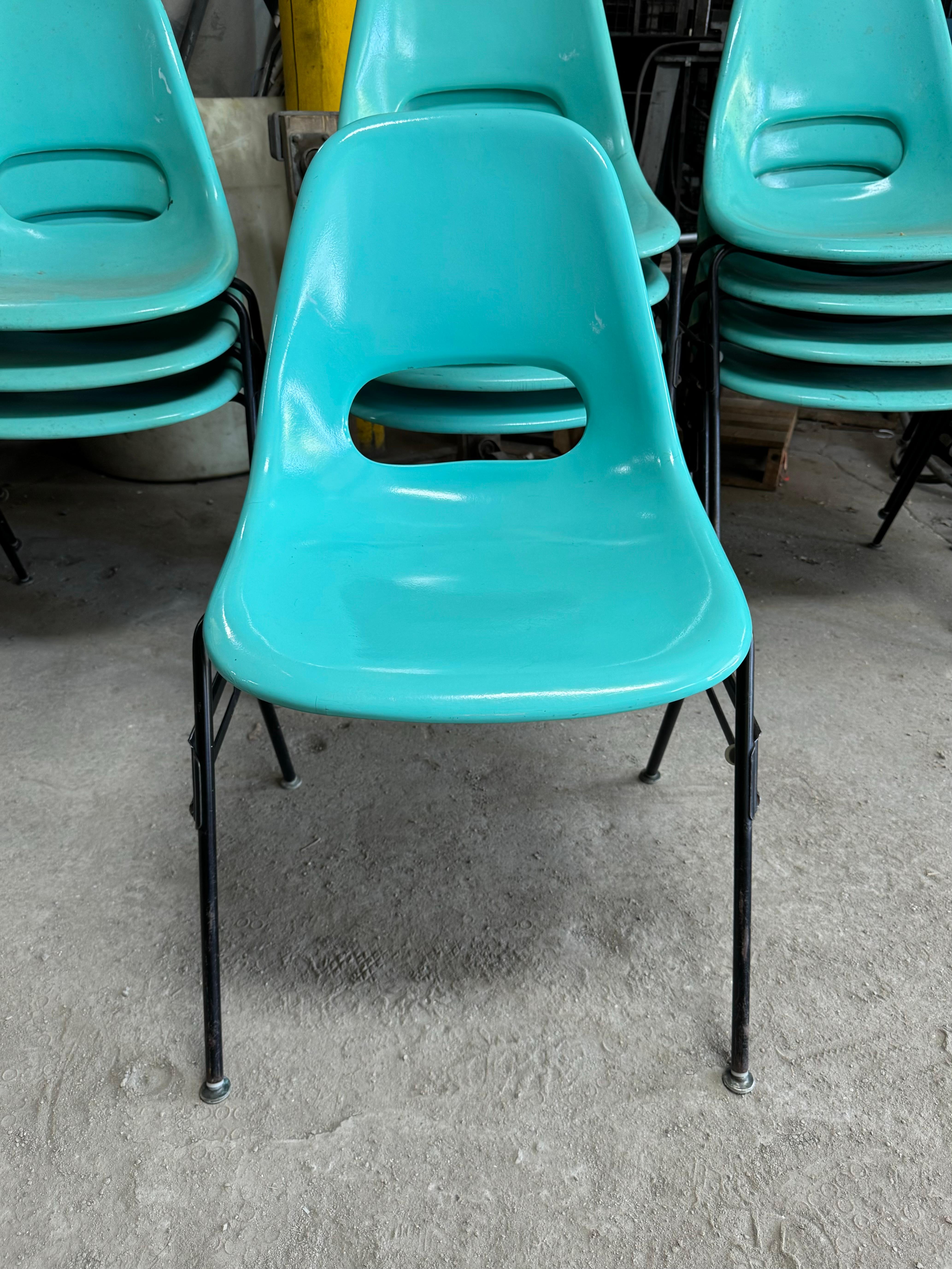 Set of 16 available .priced per chair... Krueger Metal Products .Fabulous Turquoise Color fiberglass chairs. The chair sit on black metal bases. Stackable Set of 16 Chairs, circa 1960s, Classic Modernist design.. Eames / Herman Miller Style.. Hand