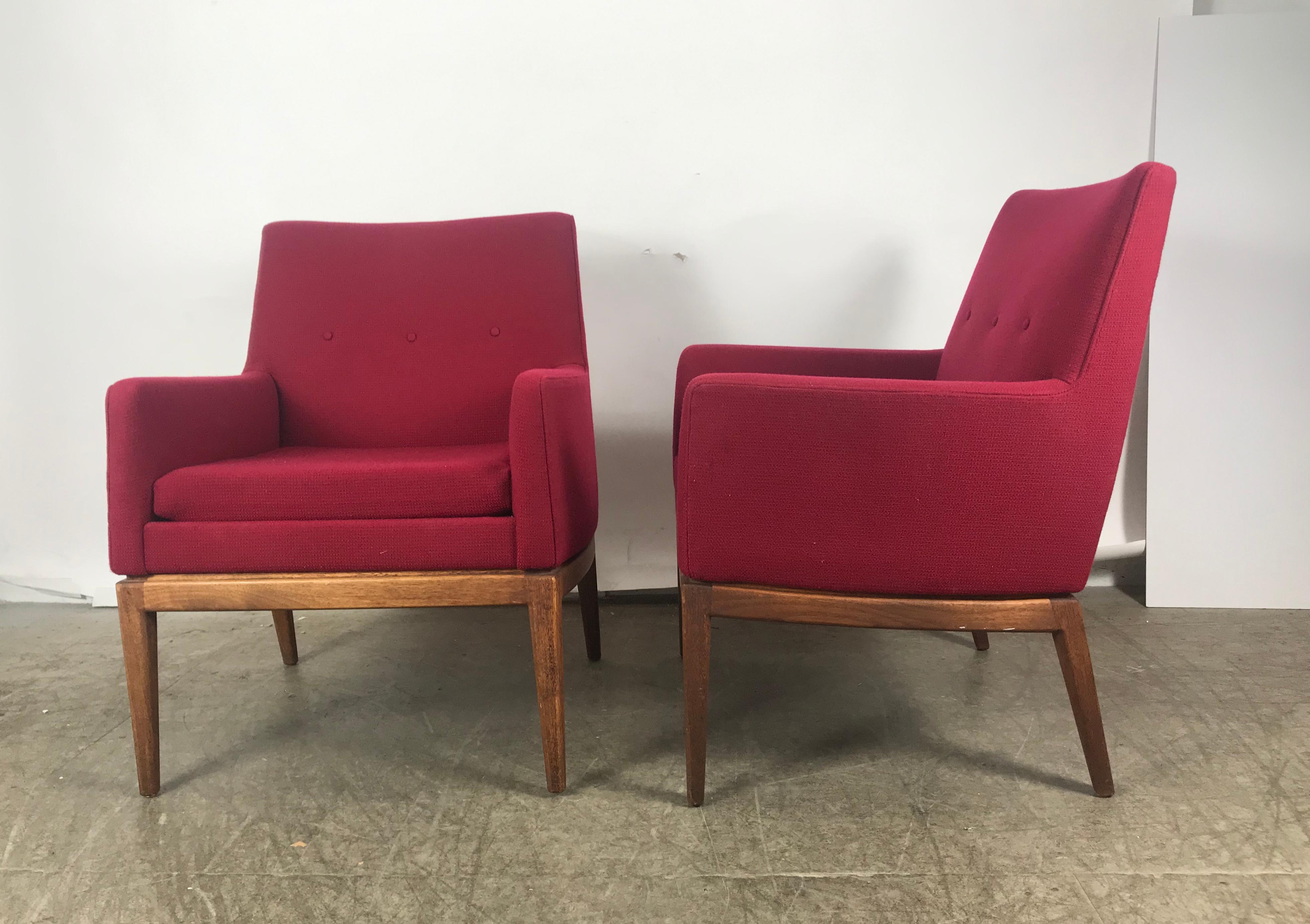 Classic modernist lounge chairs designed by Jens Risom, original labels Jens Risom Design Inc. Superior quality and construction, Retains original hot pink color high end wool fabric, sturdy, solid walnut wood frames, Classic styling, extremely