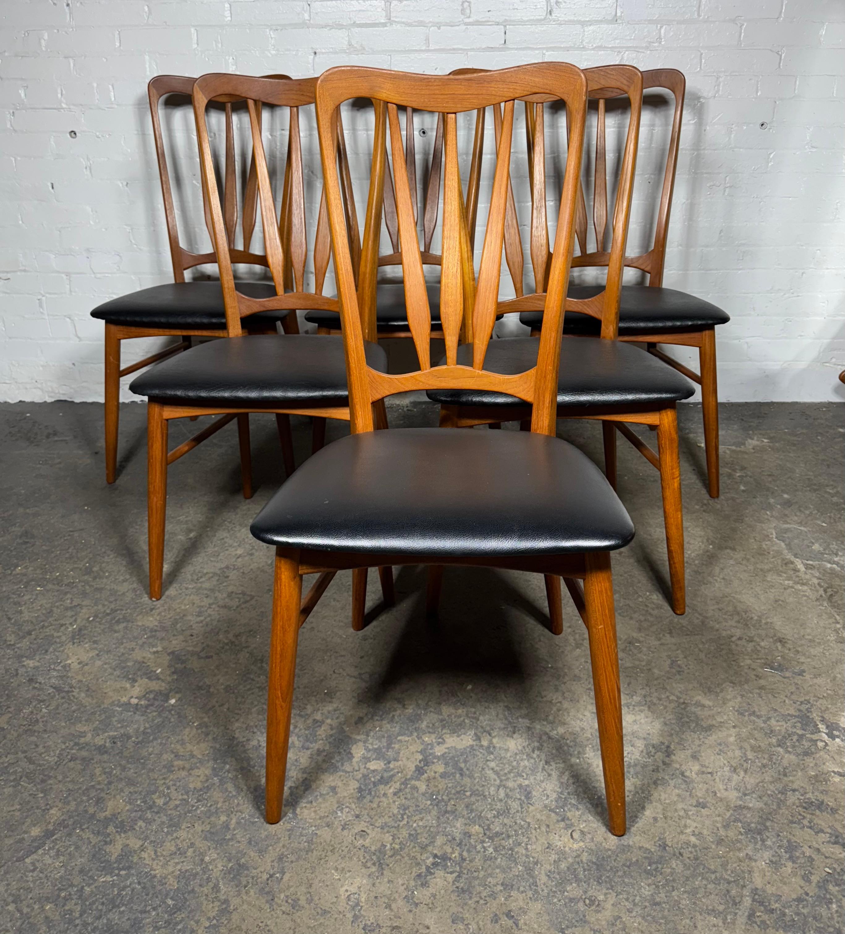 Classic Danish Modern,,Set of 6 'Ingrid' dining chairs designed by Niels Koefoed for Koefoeds Hornslet, crafted of solid teak in an elegant sculptural form includes six side chairs all with the original black vinyl upholstered seats.Also retain