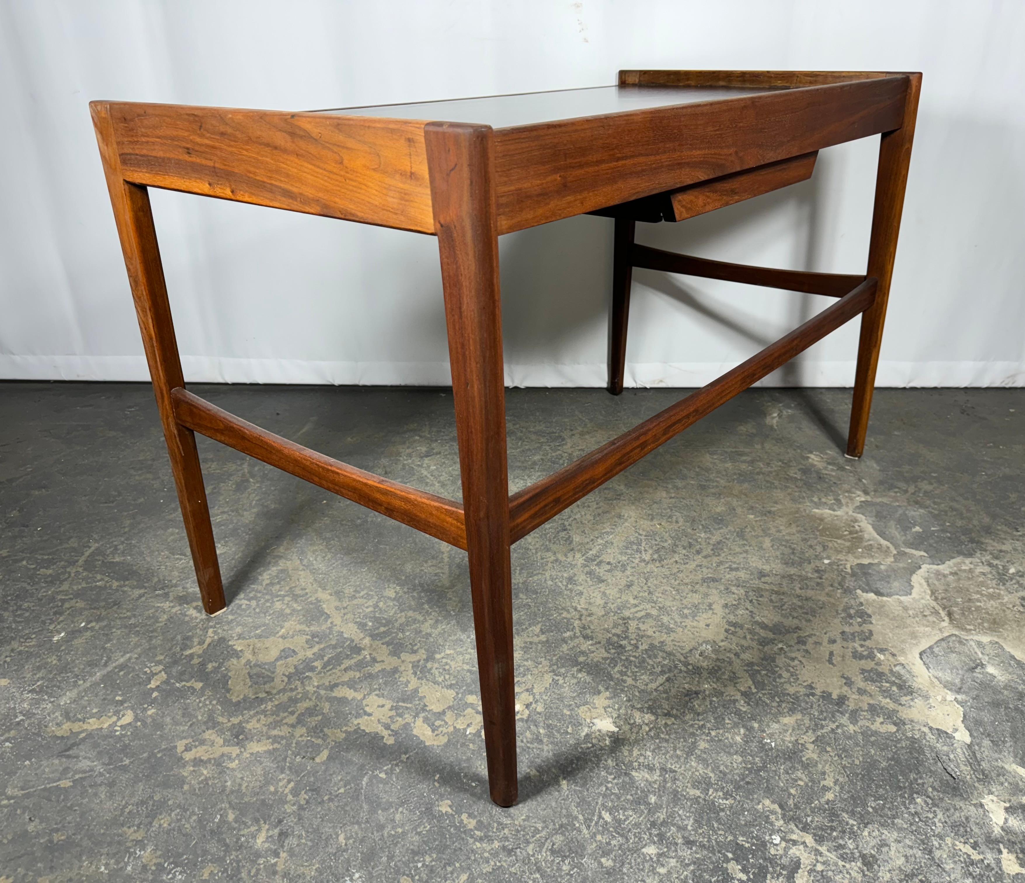 Classic Modernist walnut and leather desk by GUILDHALL CABINET SHOPS / Toronto,, Beautifully crafted,, nice simple ,elegant design,, one center drawer,, Retains original brown leather top (surface)..Hand delivery avail to New york City or anywhere