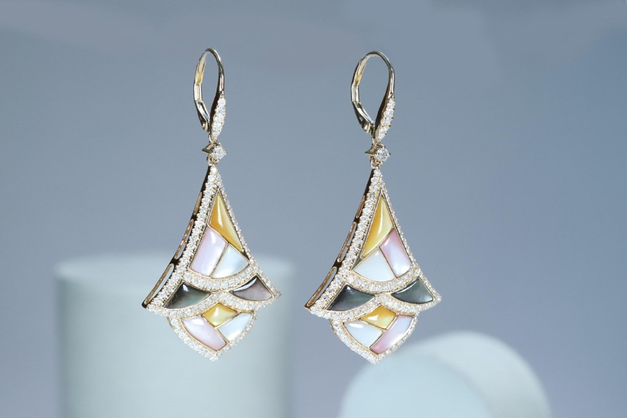 Each of these pretty earrings from Gin & Grace features a Mother Of Pearl gemstone on a lever back clasp adorned with white diamonds. These earrings are made of rich 14-karat Yellow gold with a high polish. Style: Dangle Total gemstone weight: 5.50