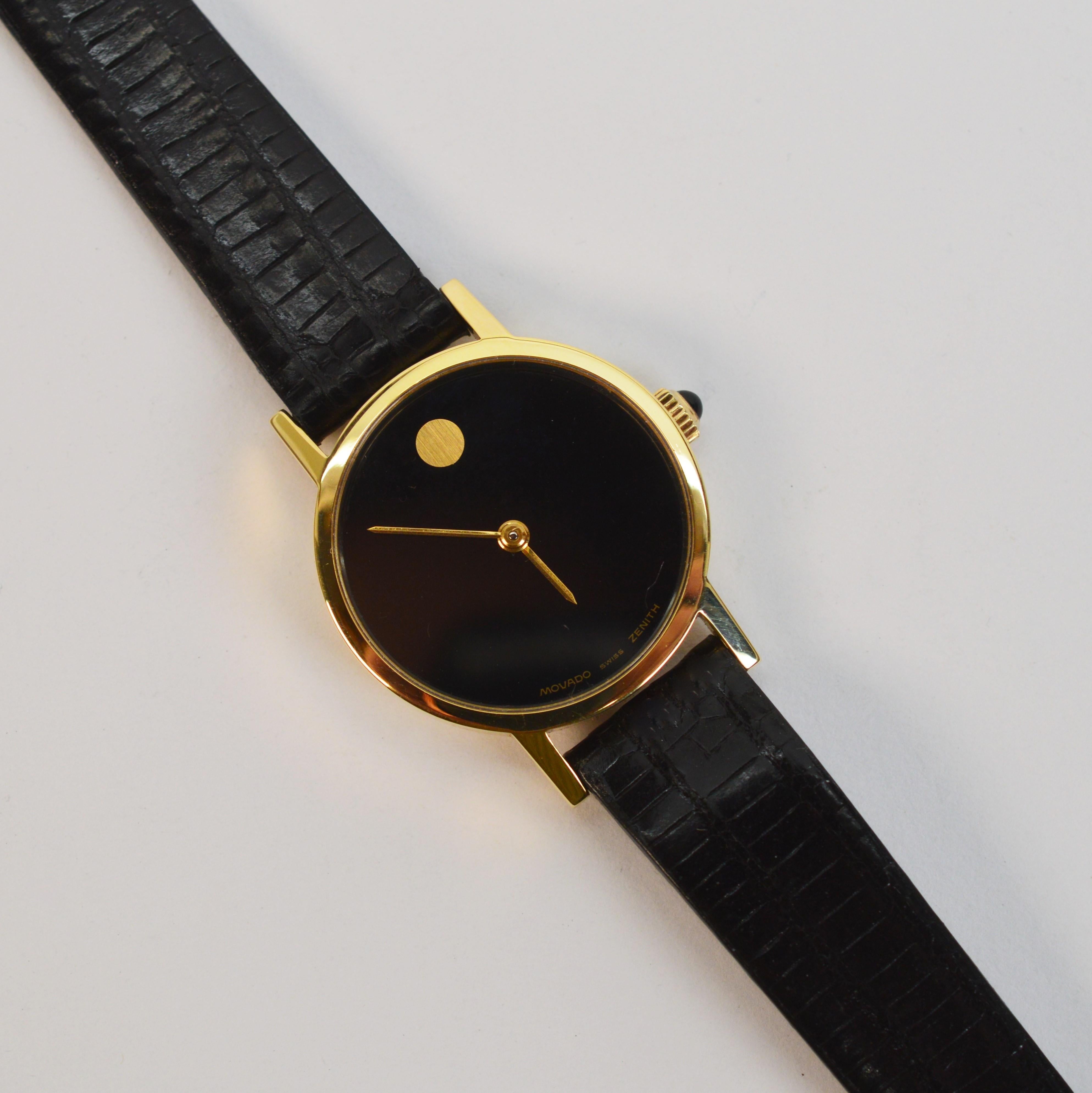 Slim and sleek, this Ladies classic 14 karat yellow gold Movado Museum Wrist Watch delivers timeless style. Swiss made with a manual wind Zenith movement. Reference number 362180305, the 14K gold case measures 24mm. Circa 1995, the watch has a