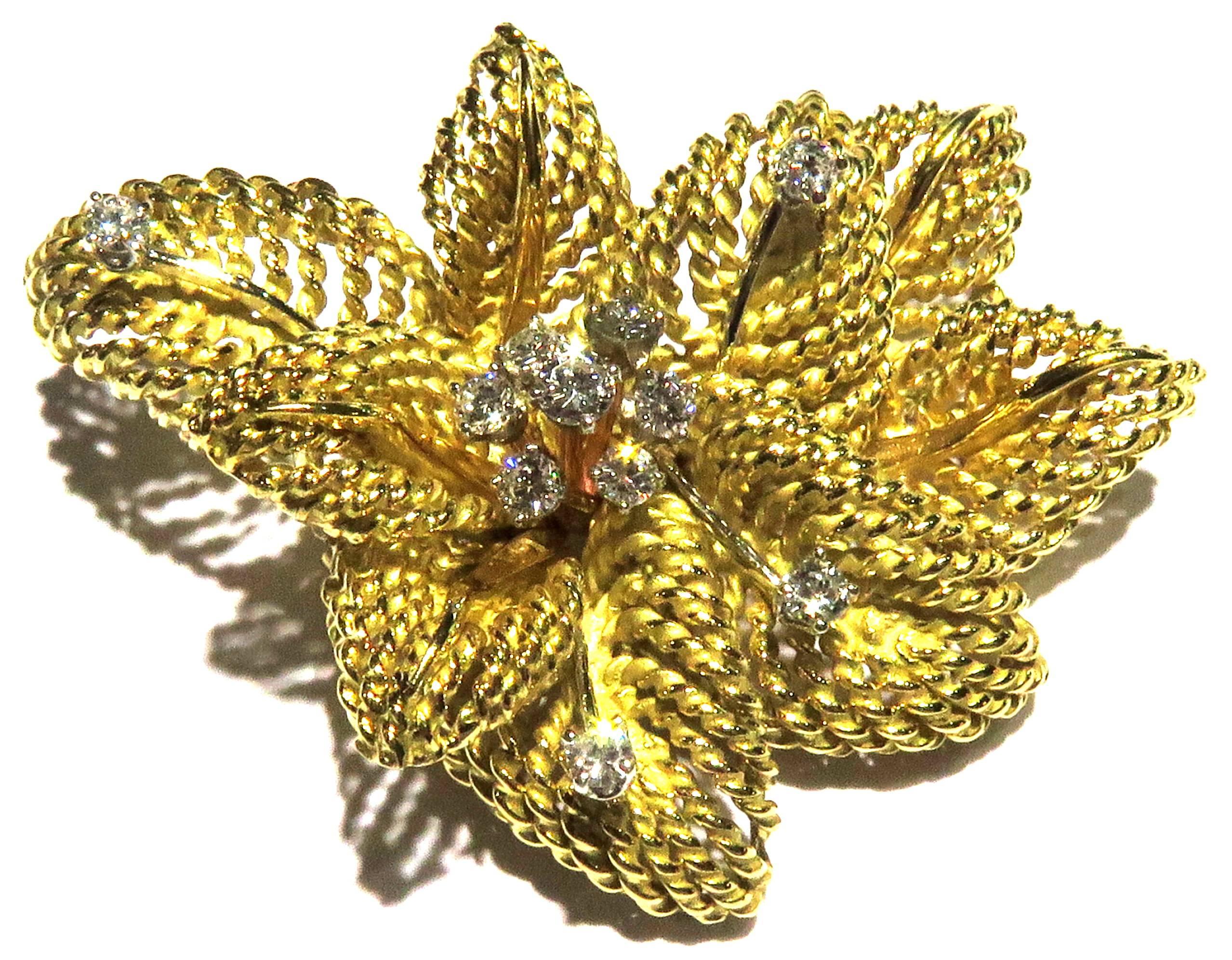 18 Karat timeless diamonds in twisted gold leaf flower motif pin. This pin features 7 round prong set diamond set in White gold which makes up center of flower and 4 prong set diamonds on white gold stems randomly set in the flower.  Approx Diamond