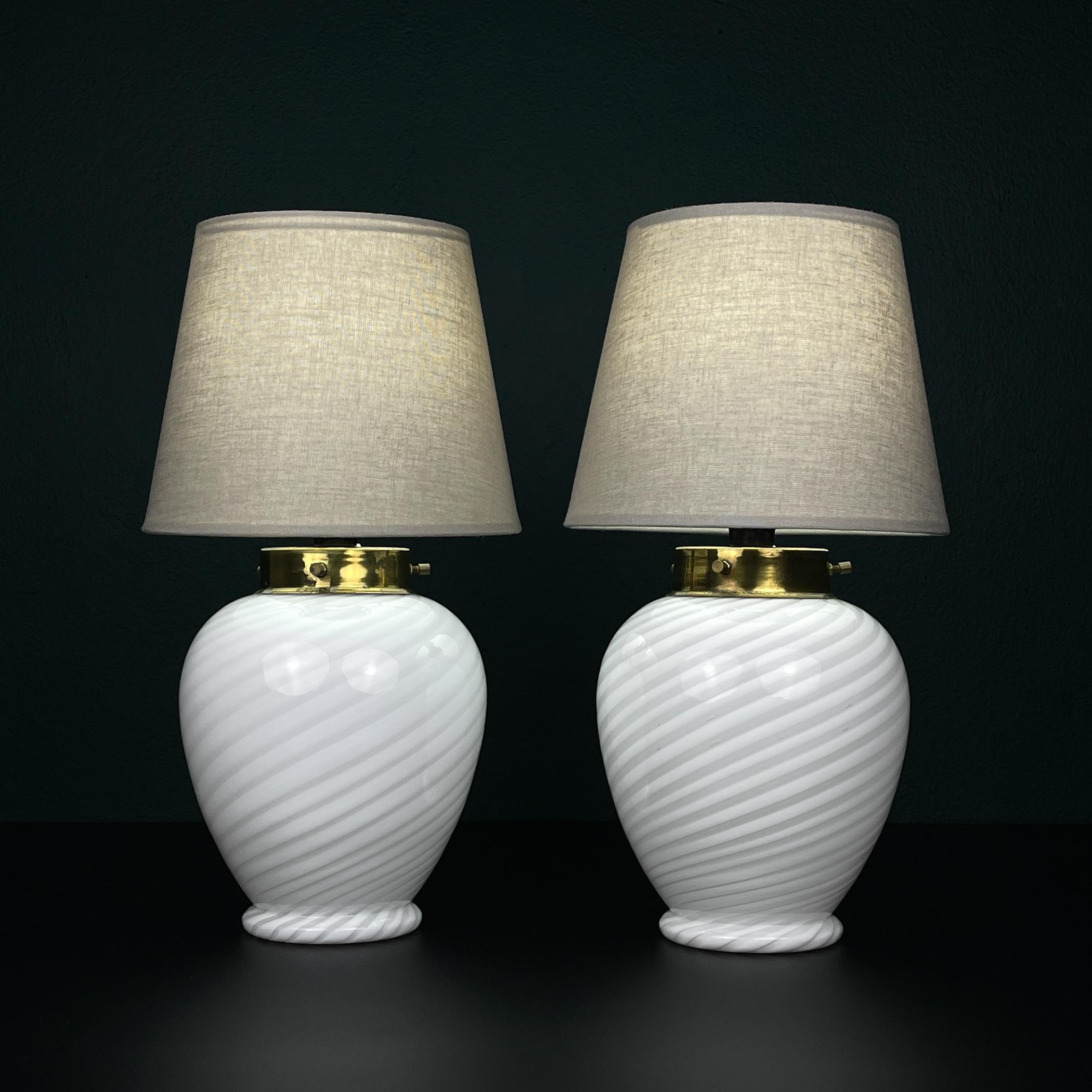 The vintage pair of beautiful swirl Murano table lamps made in Italy in the 70s.

Good vintage condition. The lampshade is not original, but new. There is the slight damage on the metal (see photo).

Dimensions:
Width: 19 cm / 7.5 inches
Height: 36