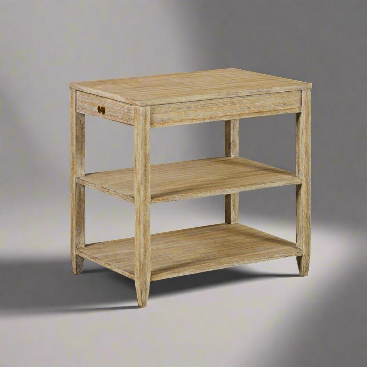 This side table boasts one drawer, two shelves, and elegant brass hardware, seamlessly combining beauty and functionality.

The weathered finish with natural highlights and distressing adds a rustic charm, making it a perfect accent piece for any