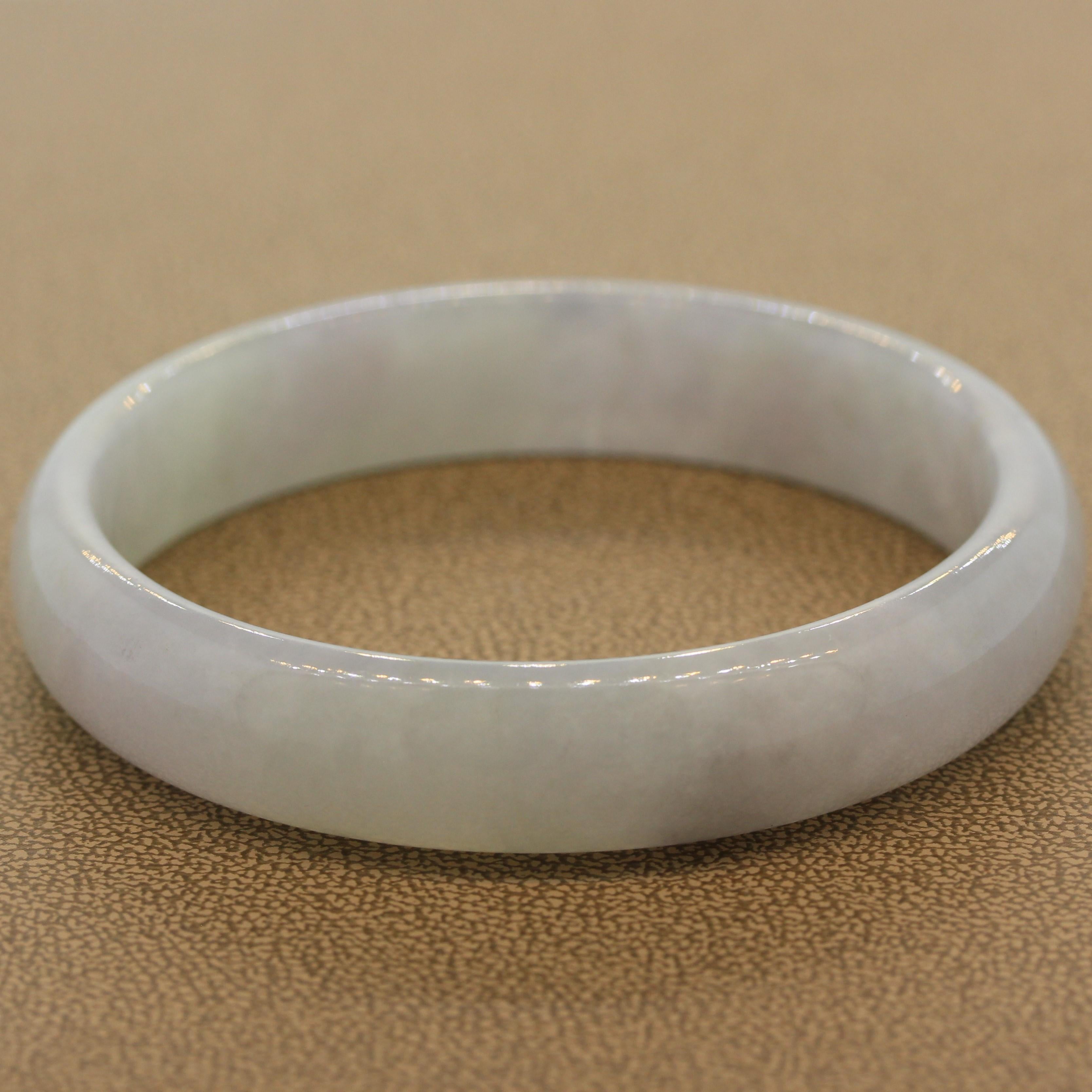 A lovely jadeite jade bangle with a soft lavender color. The luster and polish of the bangle are evident in the bright shine that comes off the bangle as the light hit it. A symbol of good luck it is said jade bring the holder food fortune.

Size 6