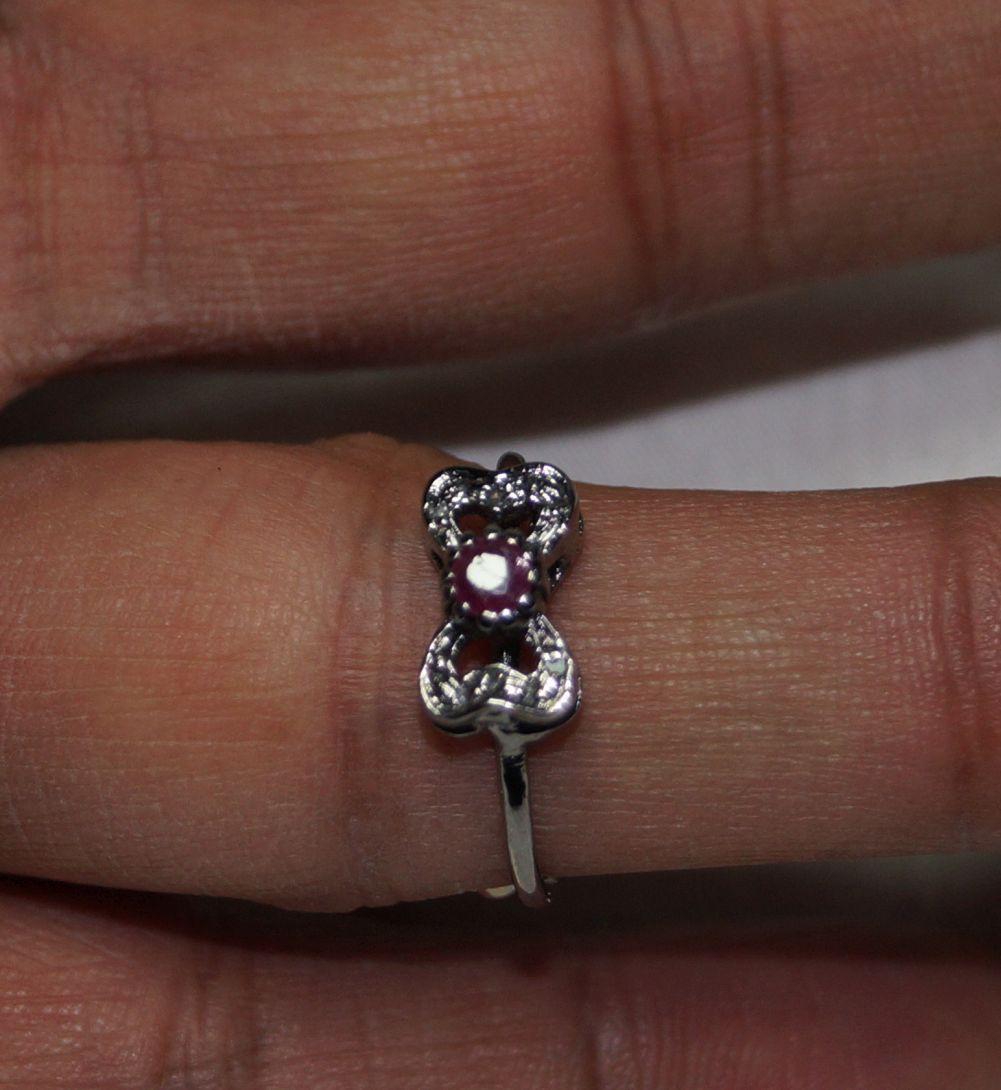 This stunning ring is one of its kind.
It consists of:
Diamond- Natural rose cut diamond
Diamond color- Tinted grey
Metal- Silver
Metal purity- 925 silver or sterling silver
Gemstone- Ruby
Gemstone origin- Natural Burma ruby