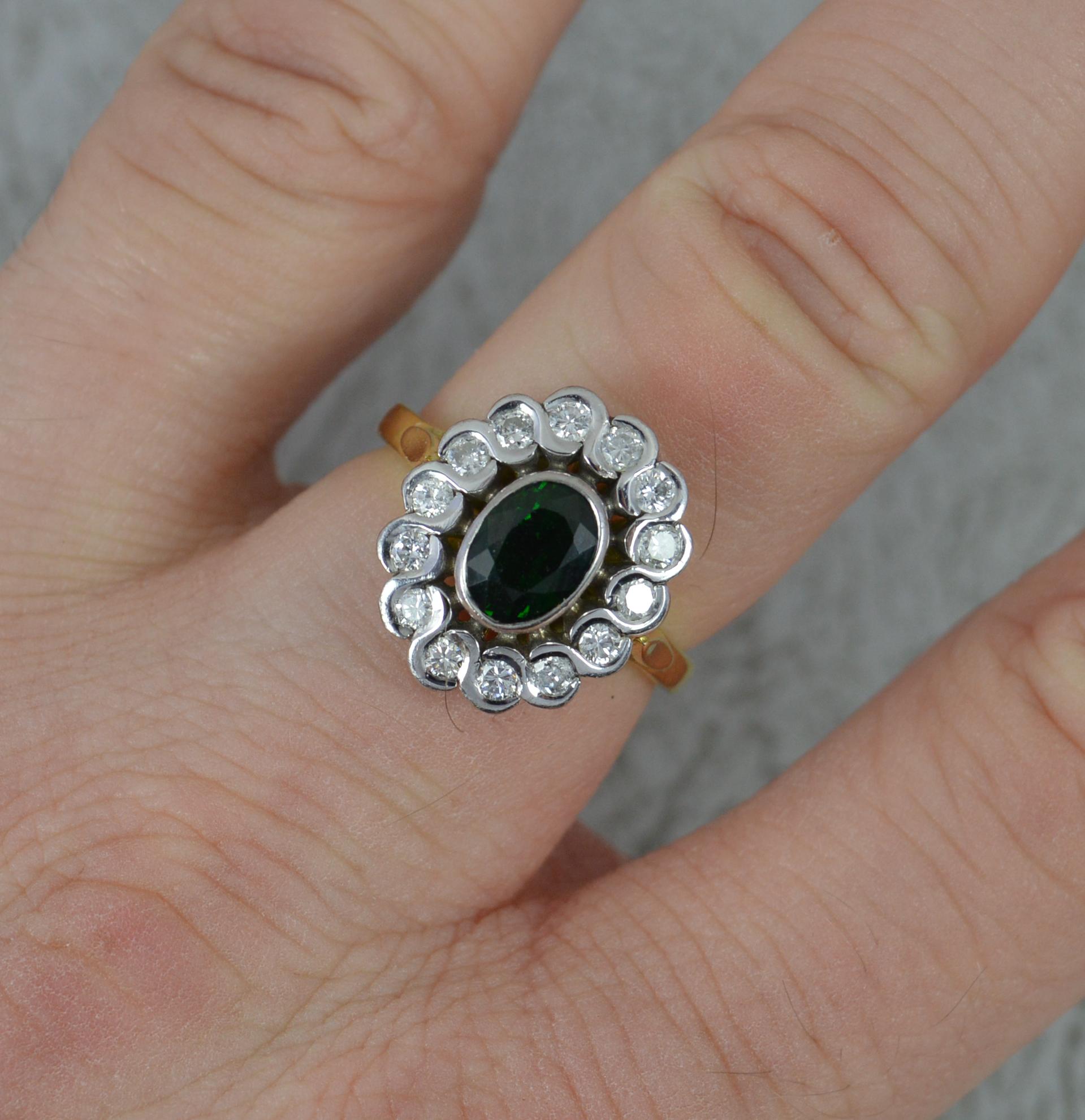 A superb tourmaline and diamond ring.
Solid 18 carat yellow gold shank with white gold head setting.
Designed with an oval cut green tourmaline to the centre and fourteen natural round brilliant cut diamonds surrounding in bezel settings. Approx