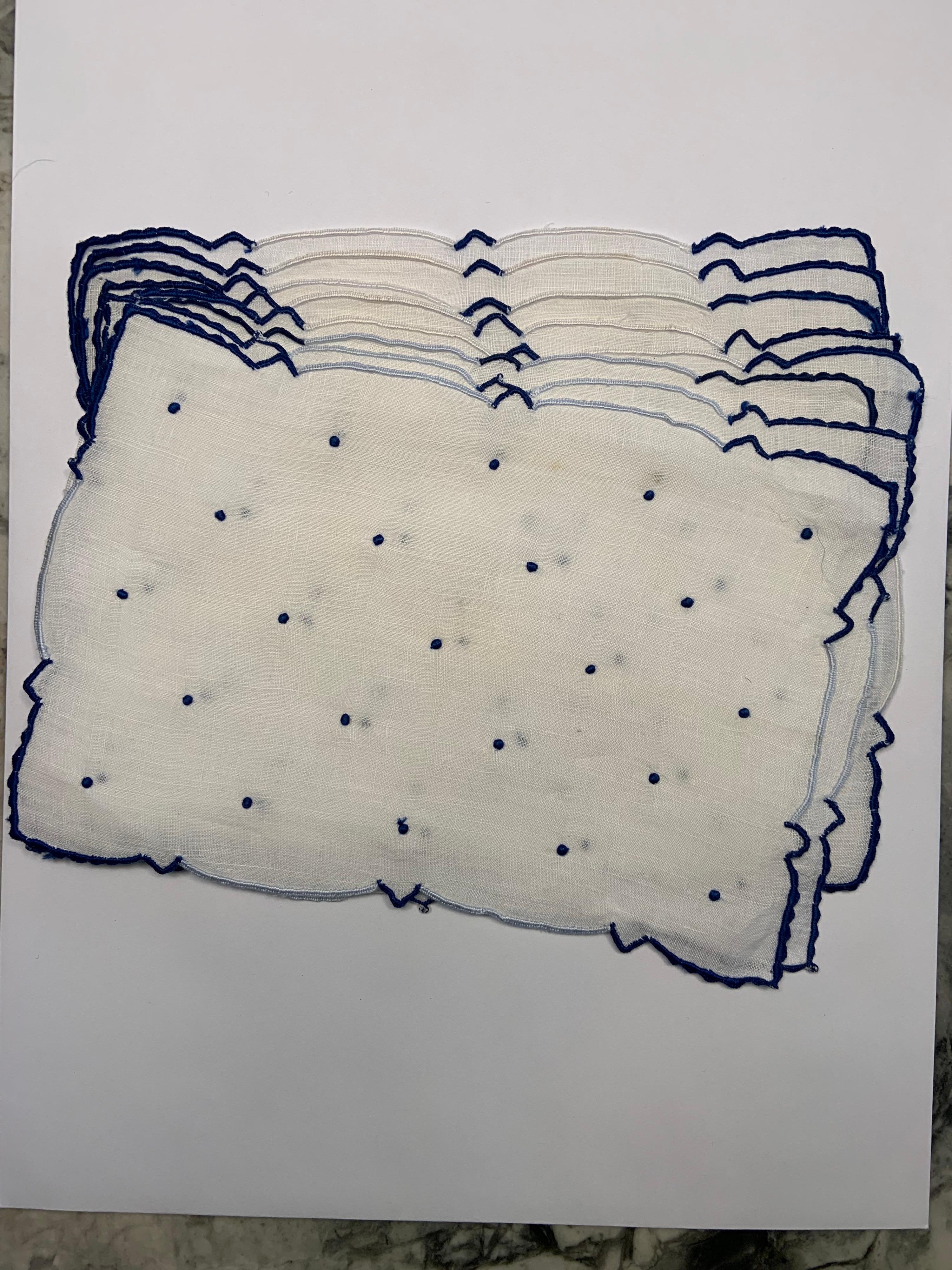 These white linen cocktail napkins have navy blue and white embroidered edges and navy blue embroidered dots in the center. Navy and white is a classic look. They are in excellent condition.