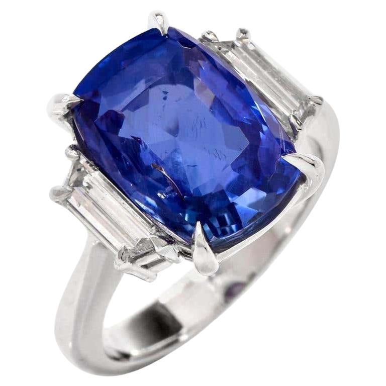 Cette bague à trois pierres en saphir et diamant de haute qualité est réalisée en platine massif. 
Le saphir bleu authentique naturel sans chaleur de taille coussin avec rapport de laboratoire GIA pèse environ 9,07 carats et mesure 13,28 x 9,41 x