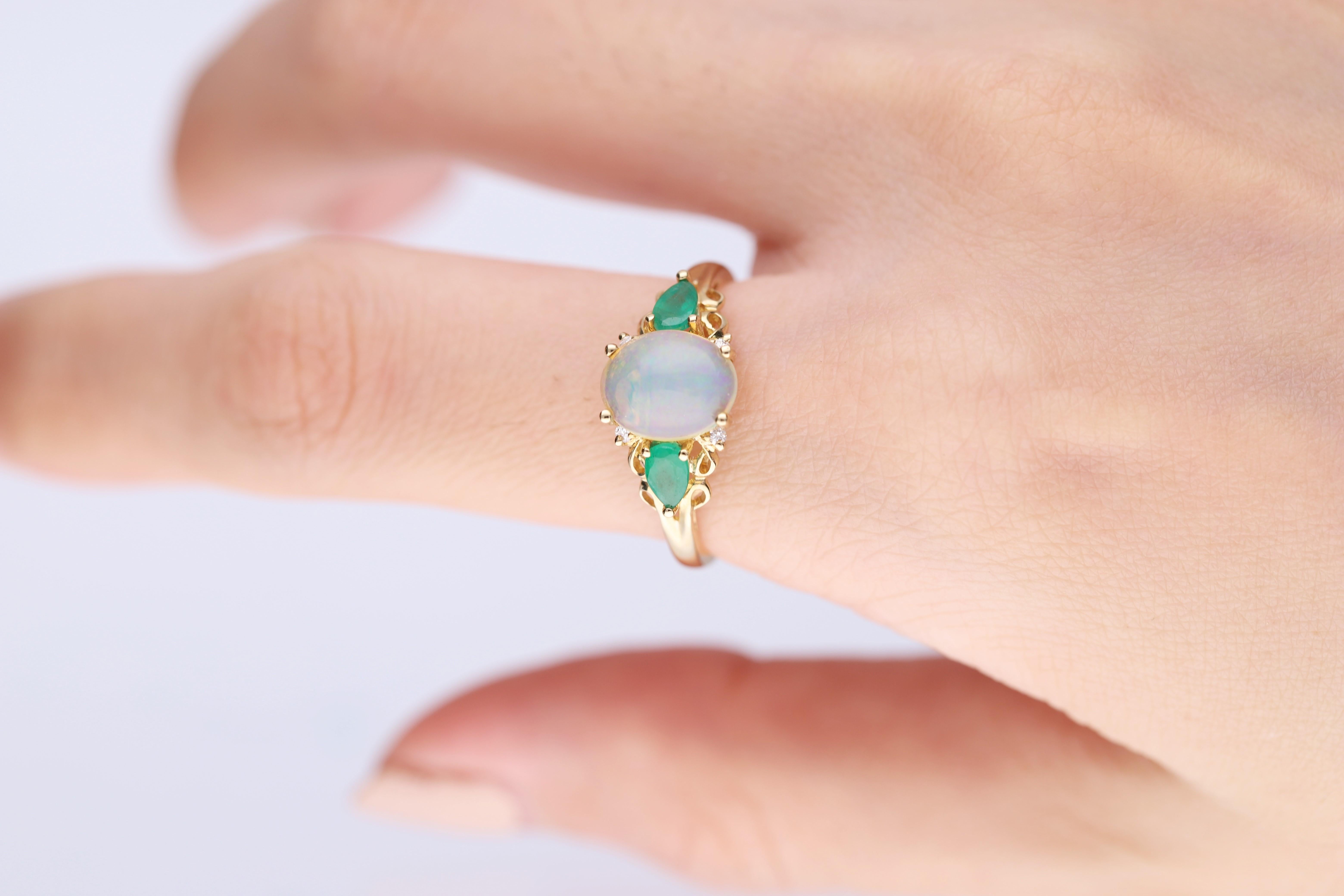 Stunning, timeless and classy eternity Unique Ring. Decorate yourself in luxury with this Gin & Grace Ring. The 10k Yellow Gold jewelry boasts Oval Cab Prong Setting Genuine Ethiopian Opal (1 pcs) 1.48 Carat, Pear cut Emerald (2 pcs) 0.41 carat,