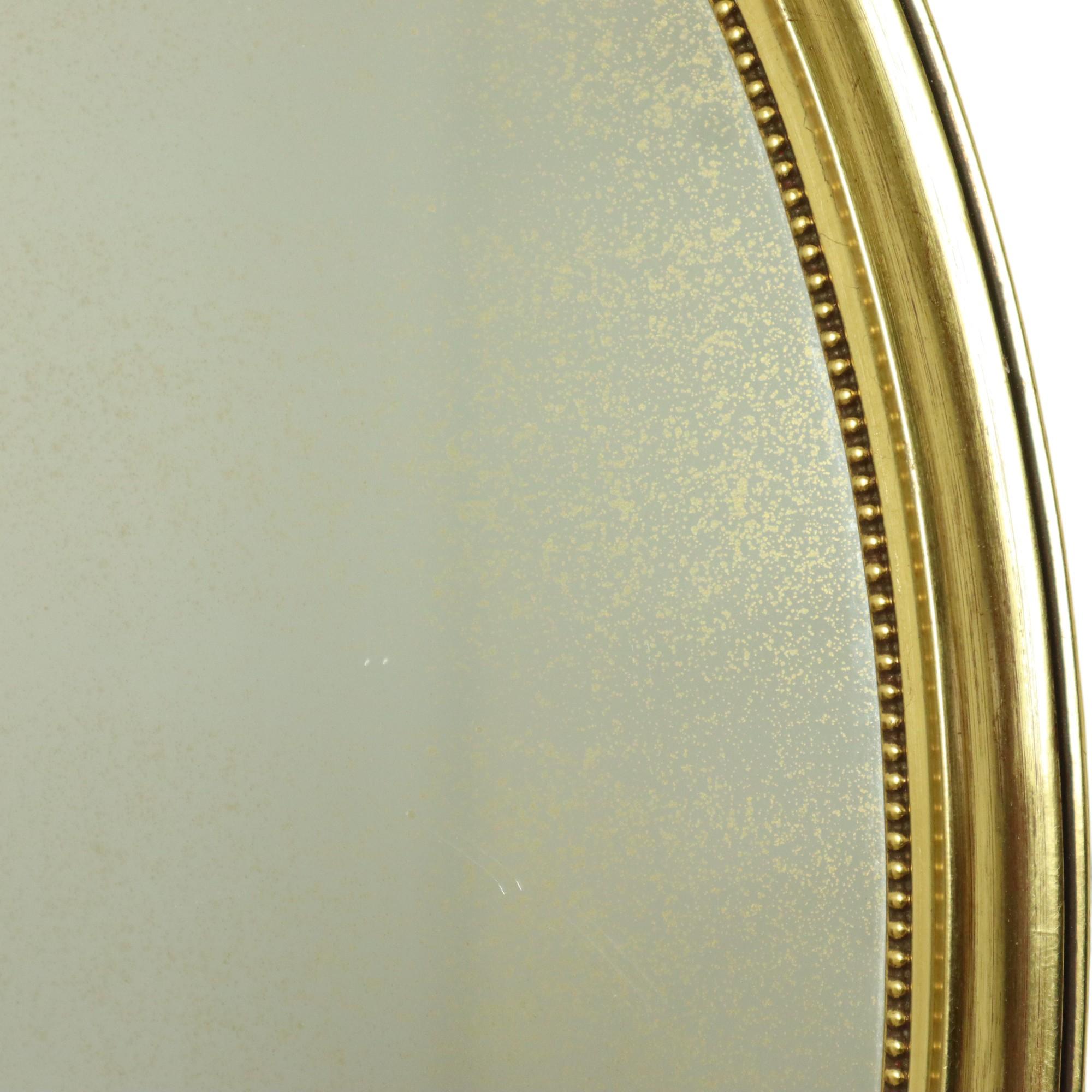 Hollywood Regency Decorazione classica ovale con nastro a specchio dorato Francia 58 cm in vendita