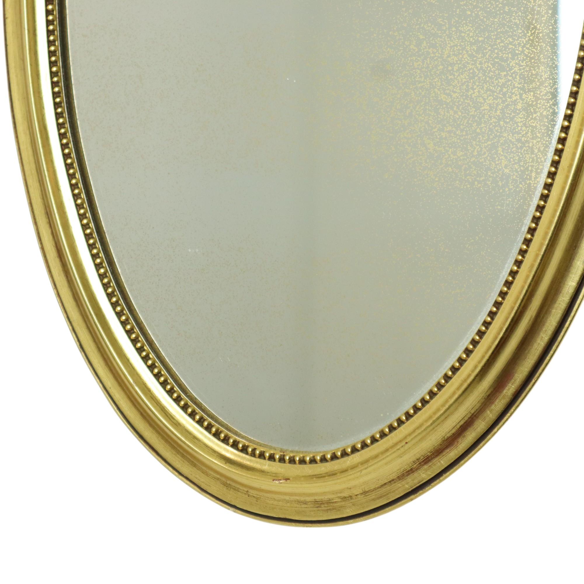 Metà XX secolo Decorazione classica ovale con nastro a specchio dorato Francia 58 cm in vendita