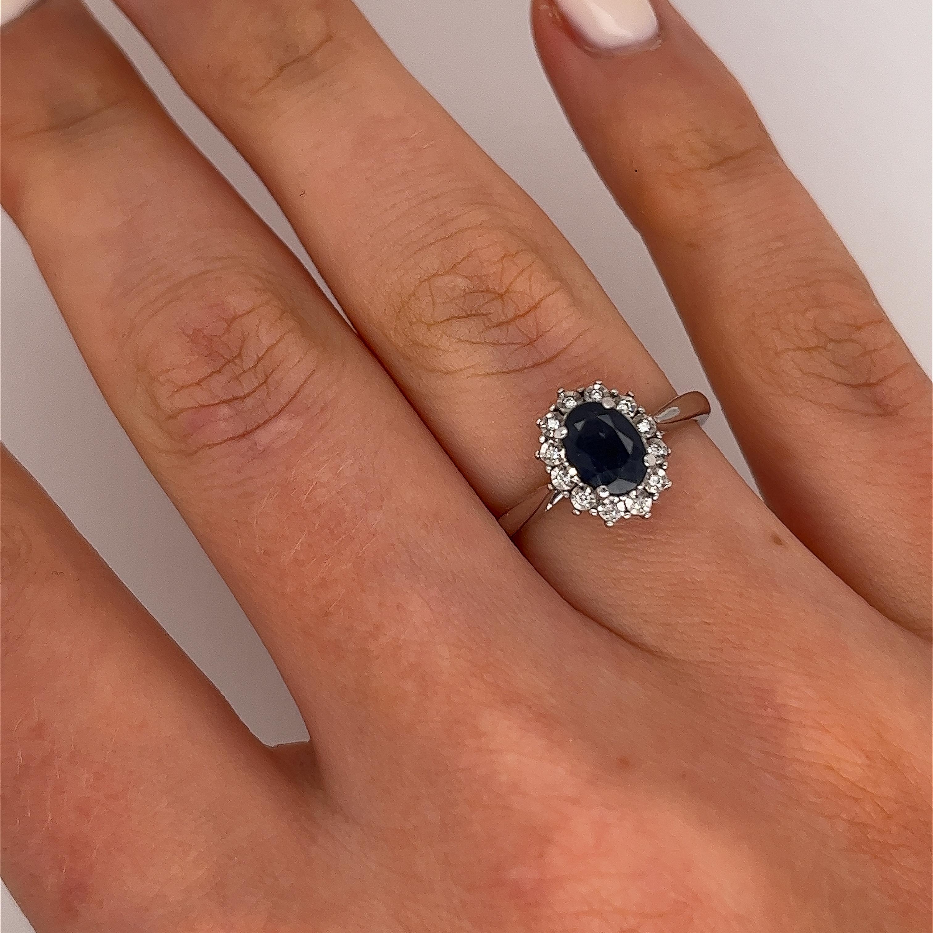 Classic Oval Sapphire Ring Surrounded by 12 Diamonds in 9ct White Gold In Excellent Condition For Sale In London, GB