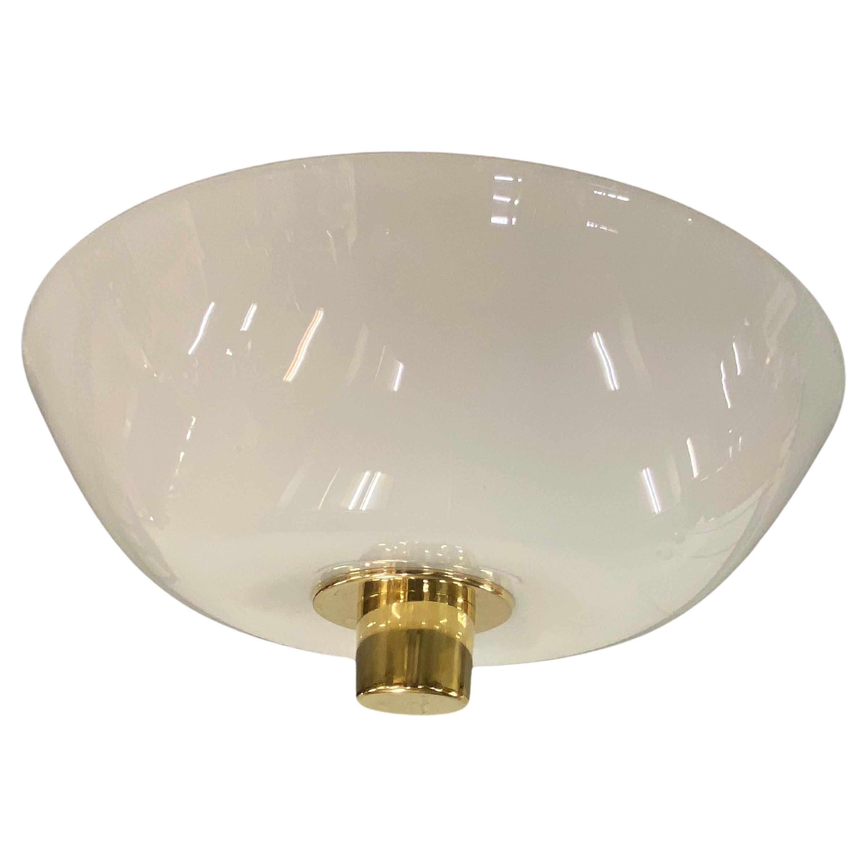 A beautiful ceiling lamp by Paavo Tynell. This model came with different size glass version shades, mainly 40 , 50 or 60 cm long. 
This particular example is in completely original condition. The vanila white colored glass as well. 
This lamp can be