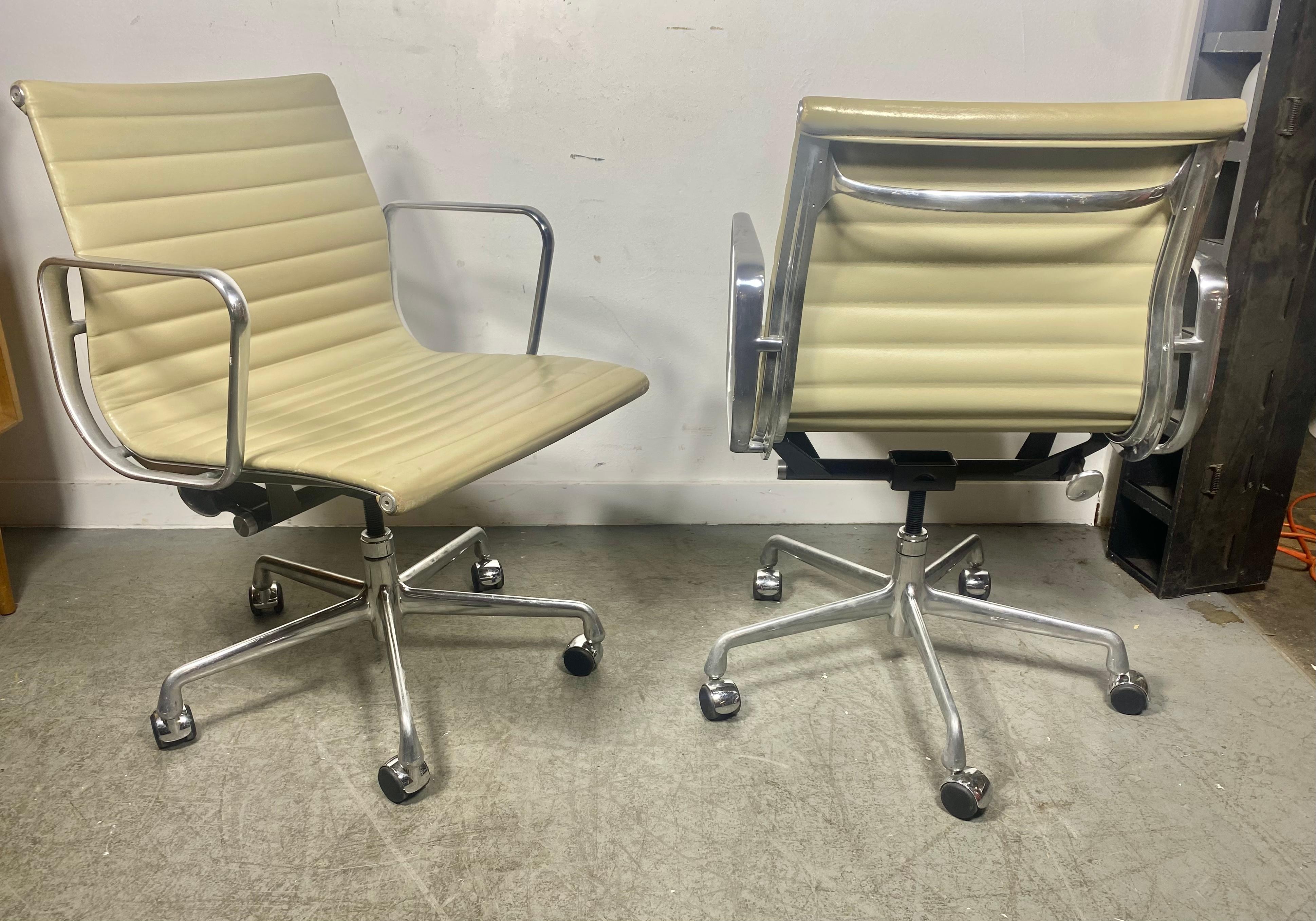 Stunning pair Eames Aluminum group chairs, designed by Charles and Ray Eames for Herman Miller, American, circa 2007. Designed in 1958, Probably the most comfortable desk chair on the planet. These examples custom ordered in an ivory leather ribbed