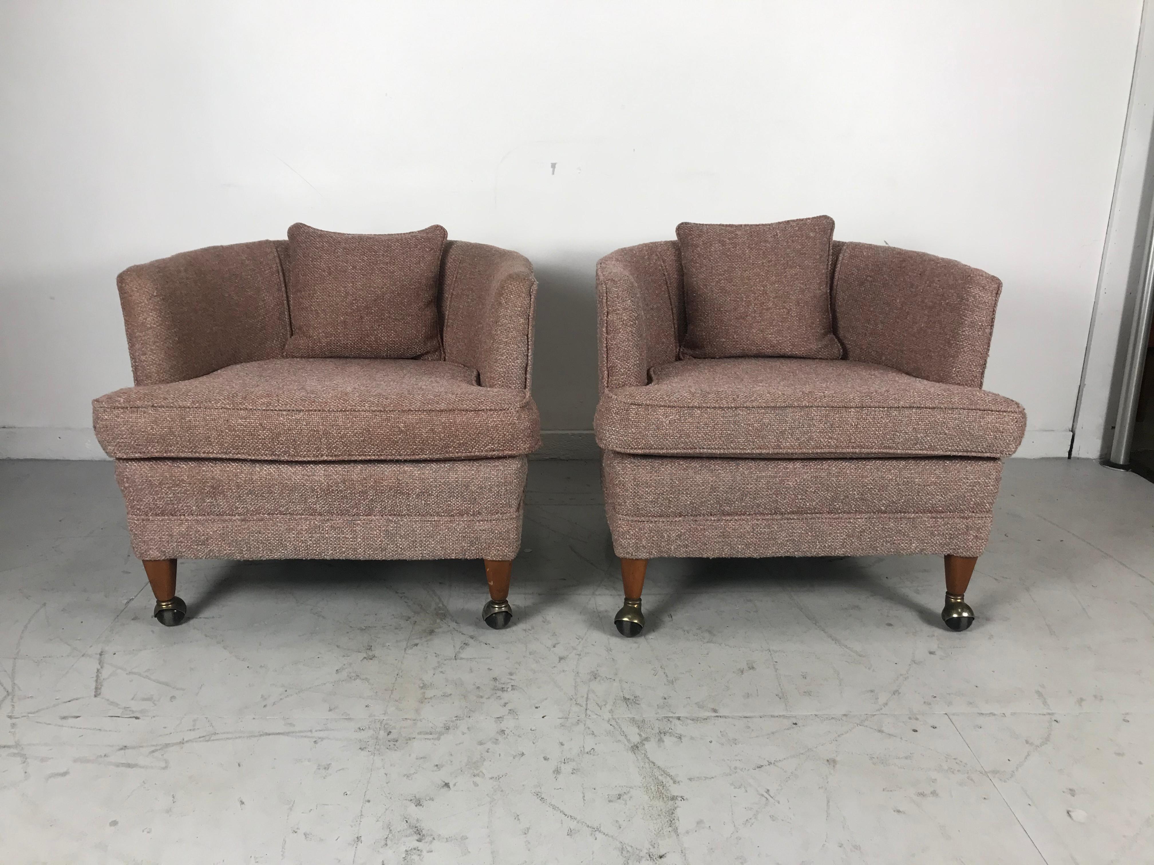 Classic pair of modernist tub chairs on Castors. Manufactured by Tomlinson Furniture Co. Nice pair lounge chairs, retains original fabric. Extremely comfortable.