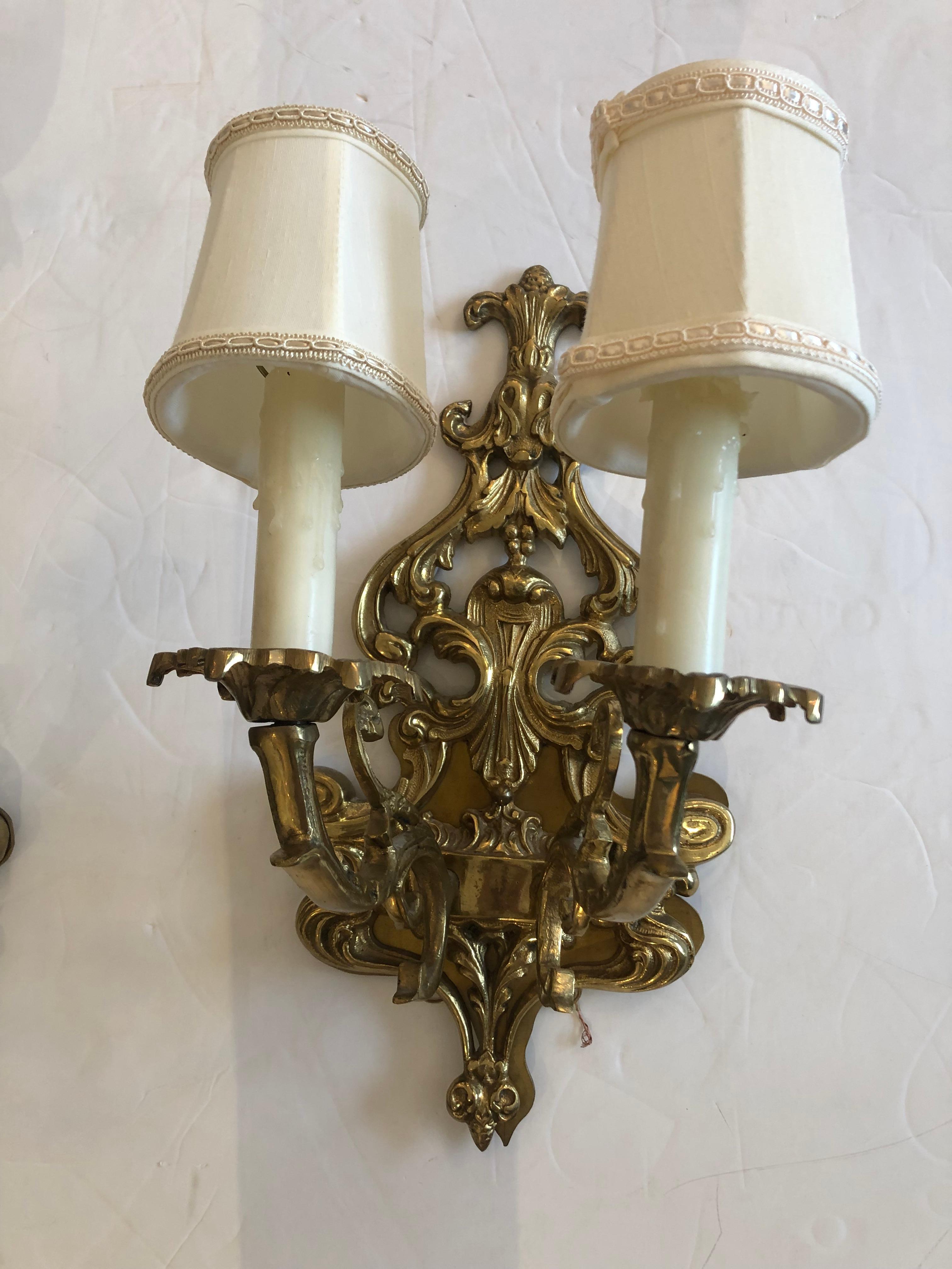 Beautiful medium sized brass wall sconces with 2 arms each and pretty silk shades.
