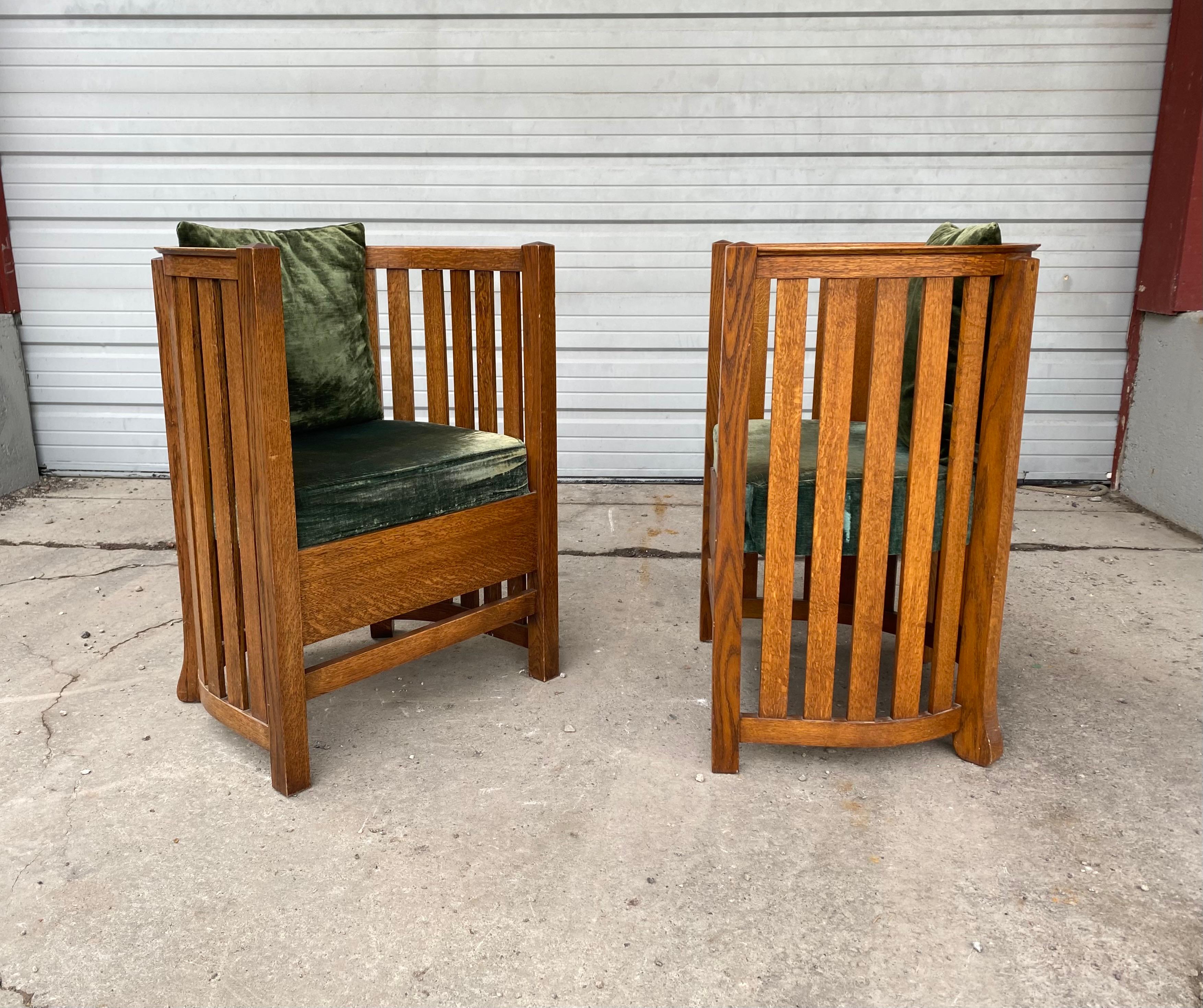 Classic pair of oak barrel chairs, in the manner of Frank Lloyd Wright, attributed to Plail Brothers Chair Company furniture, Classic Arts & Crafts design. Nice quality and construction. Hand delivery avail to New York City or anywhere en route from