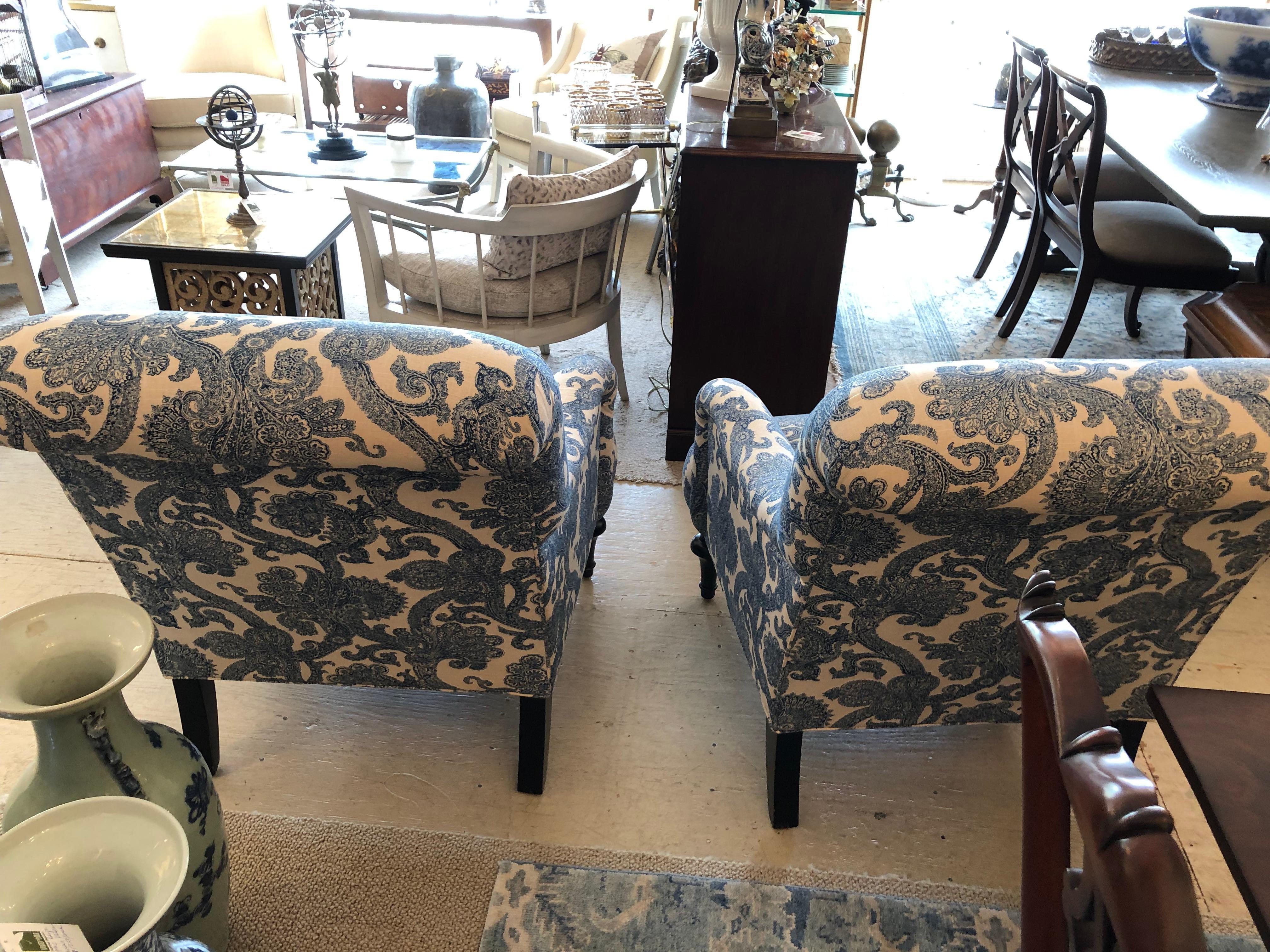 Oversized and super comfy classic pair of Lexington upholstered club chairs having welcoming blue and white pattern, rolled arms, attached seat cushion, and dark walnut turned feet on front with straight feet on the back.