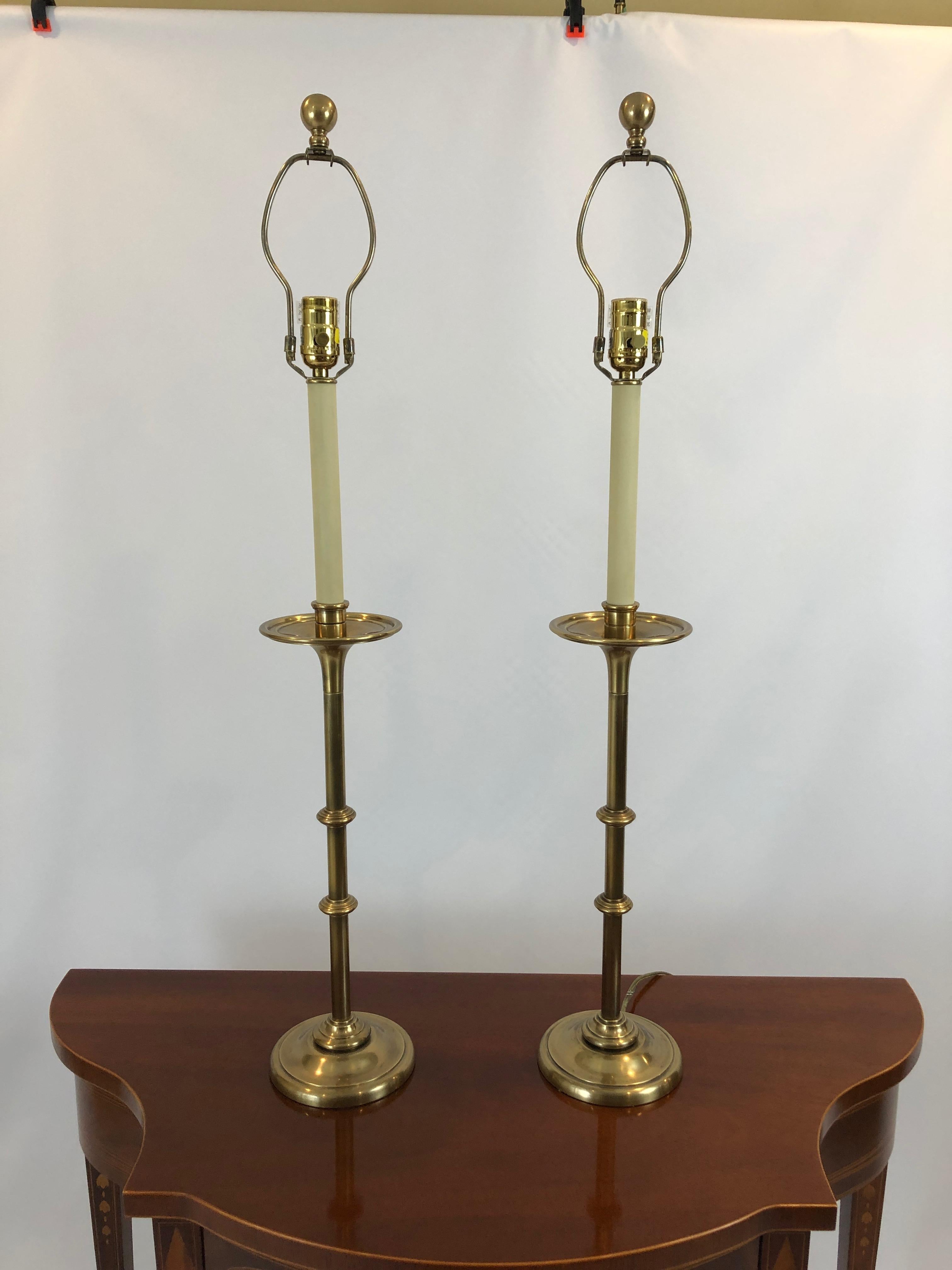 Classically elegant pair of antiqued brass candlestick lamps having custom black shades lined in antiqued gold foil.
Base is 6