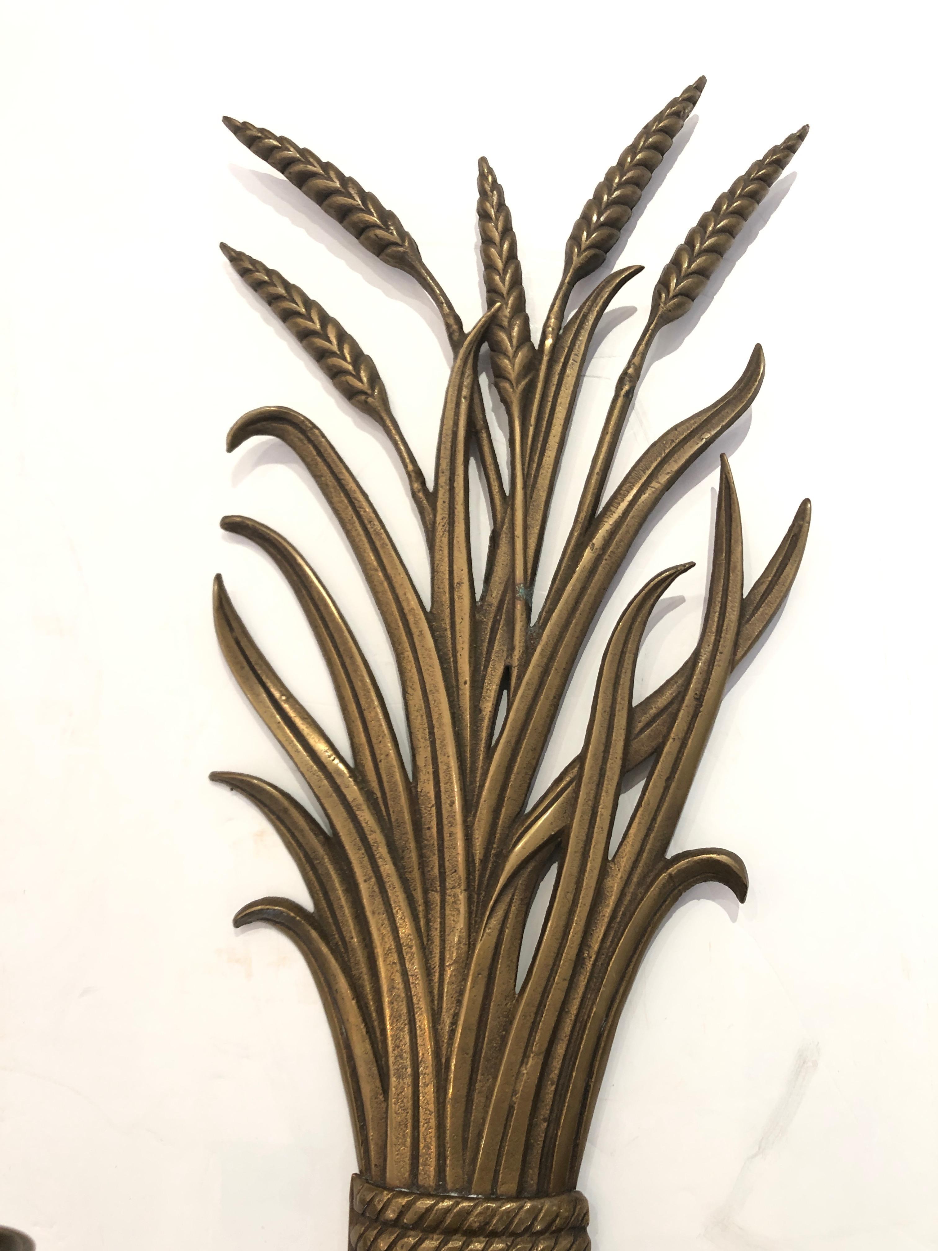 Two handsome brass candle sconces, two arms each, in a classic wheat sheaf motife.