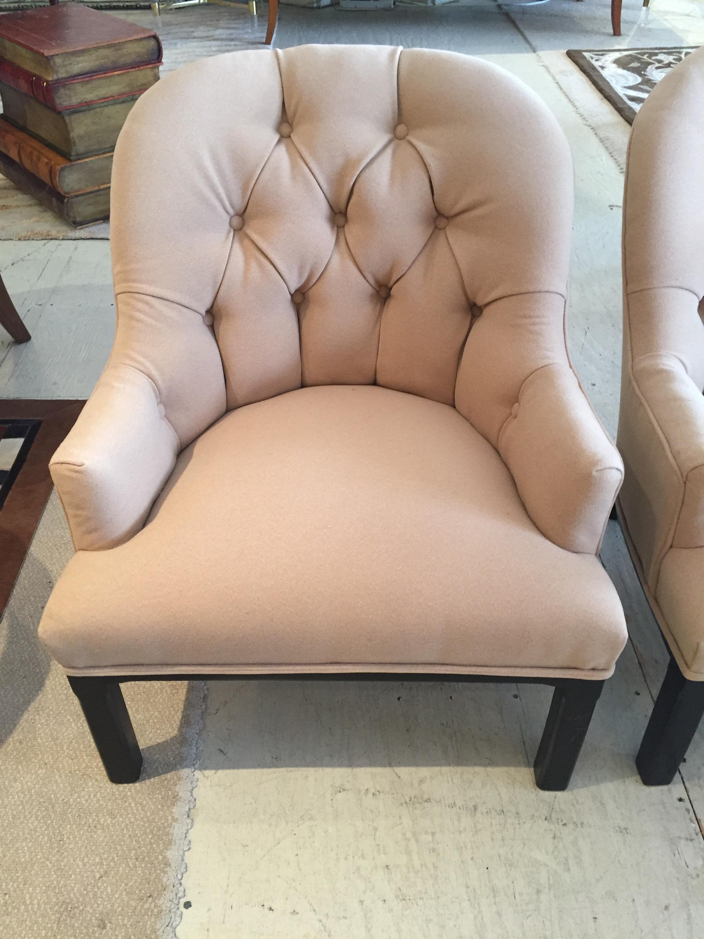 Mid-Century Modern pair of Dunbar style club lounge chairs having button tufted barrel back tub shaped backs and ebonized Parsons legs. Newly dressed up in soft elegant camel hair upholstery.
Measures: Seat height 15.
   