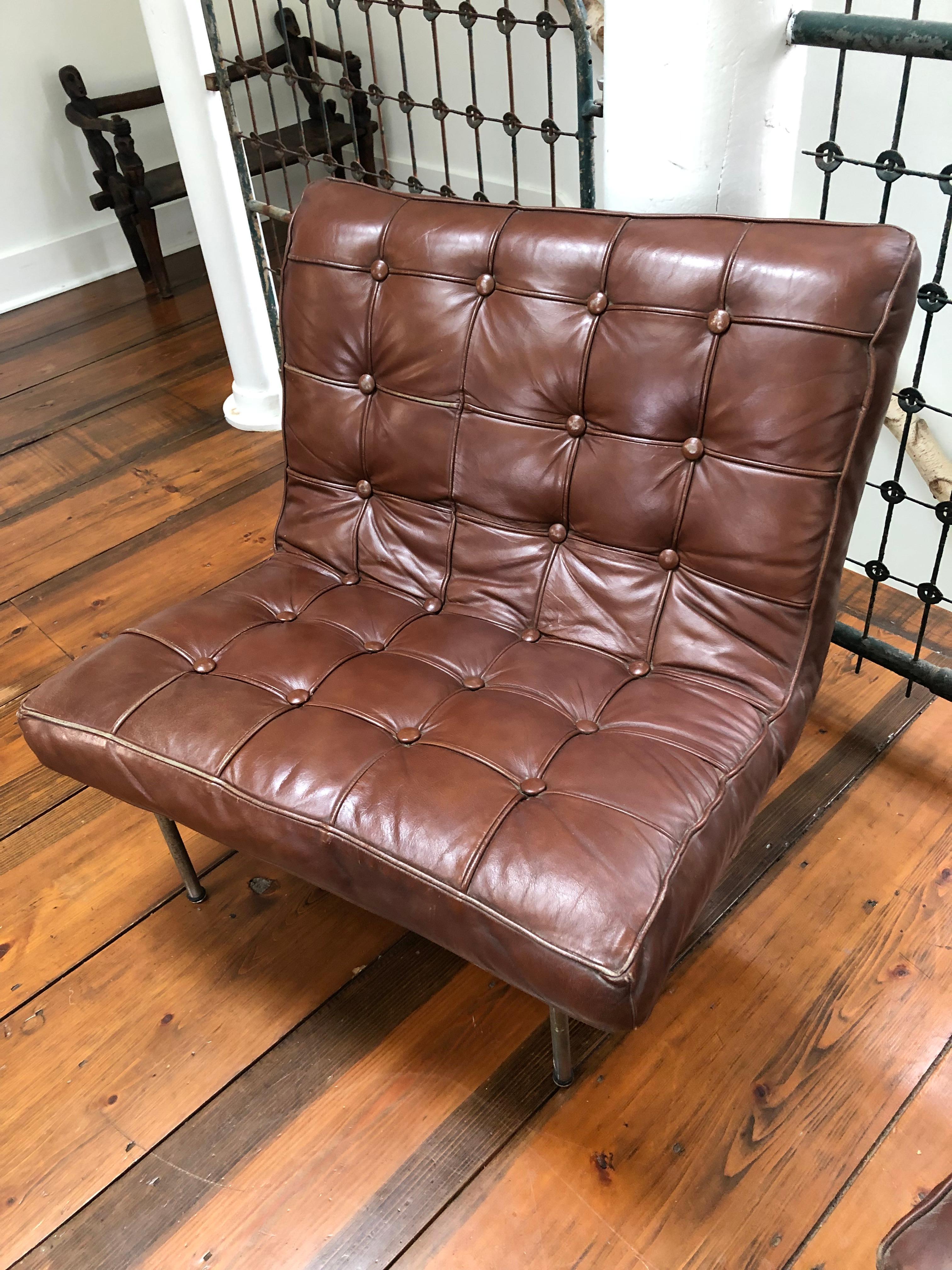 Iconic Barcelona style heavy solid chocolately leather and steel club chairs. A fabulous hipster look in their slightly distressed condition. No rips or tears. Heavy leather body sits on steel frames and are substantial enough to not need straps.