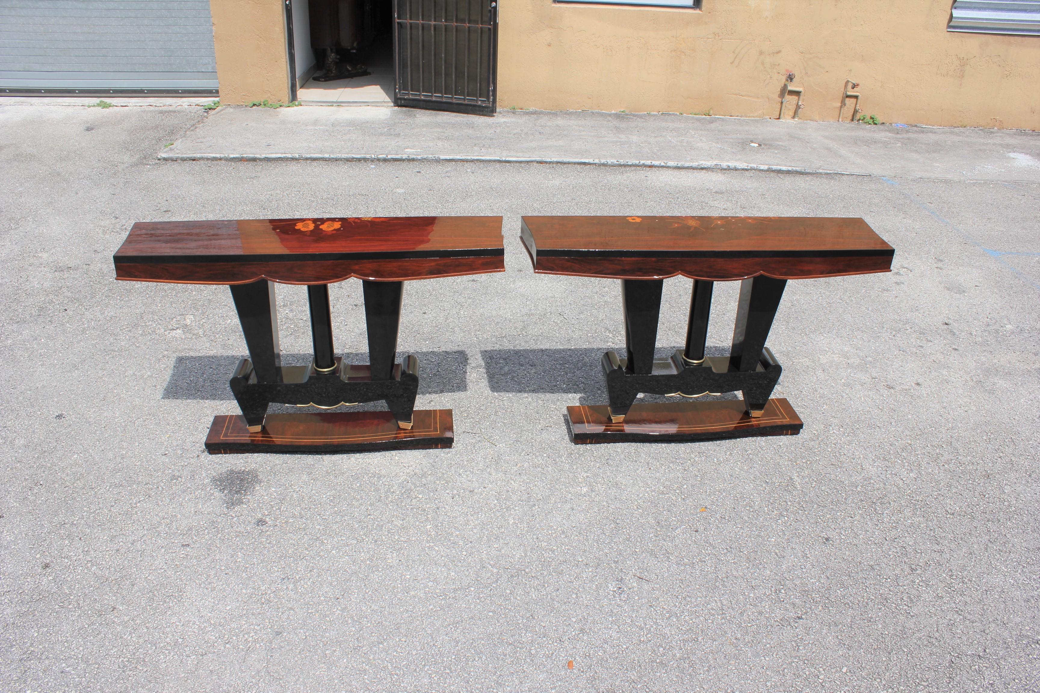 Classic pair of French Art Deco exotic Macassar ebony console tables, circa 1940s. Beautiful parquetry design exotic Macassar ebony top with black lacquer base, high gloss lacquer finish in both side, with beautiful bronze hardware detail, that rest