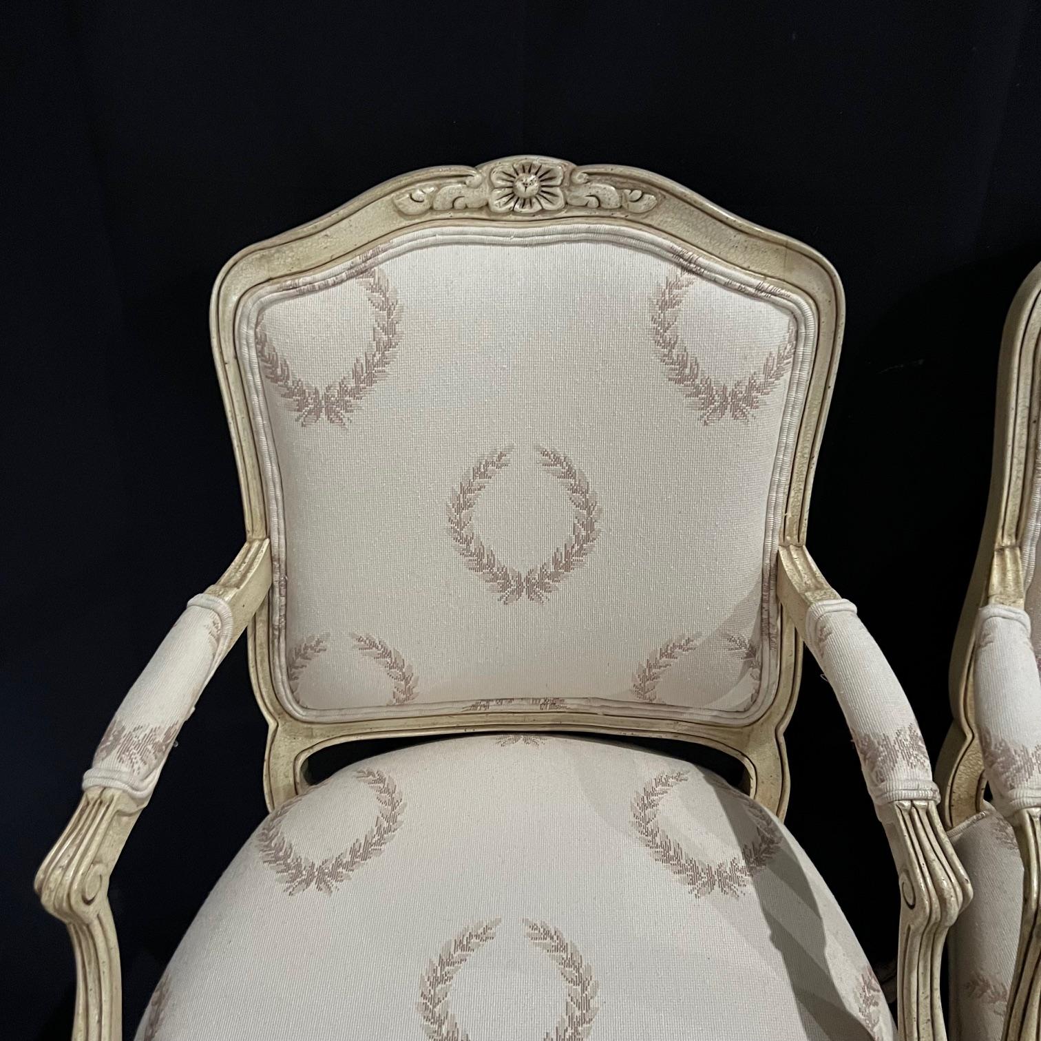 Elegant and classic vintage Louis XV armchairs or fauteuils in immaculate condition, with lovely contrasting fabric on back. Classic Louis XV carved florets and tapered cabriole legs. Original off white paint.
#4675
