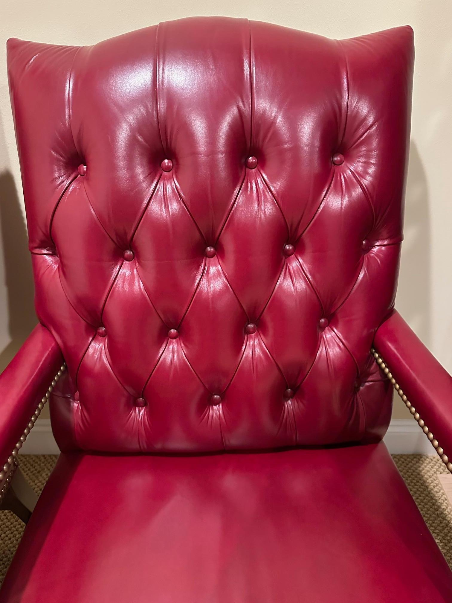 Pair of Hancock & Moore classic tufted red leather Chesterfield style arm chairs.
Seat: 17” D x 17” H
Arm: 26” H 
Seip