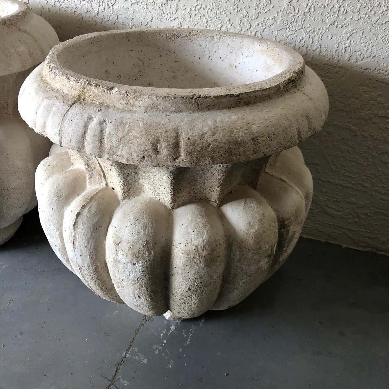 Wonderful pair of cast stone bulbous gadrooned garden urns each standing on its original extended socle and drilled for proper water drainage. Classic exterior, landscape and garden ornaments. 
#5218.


   