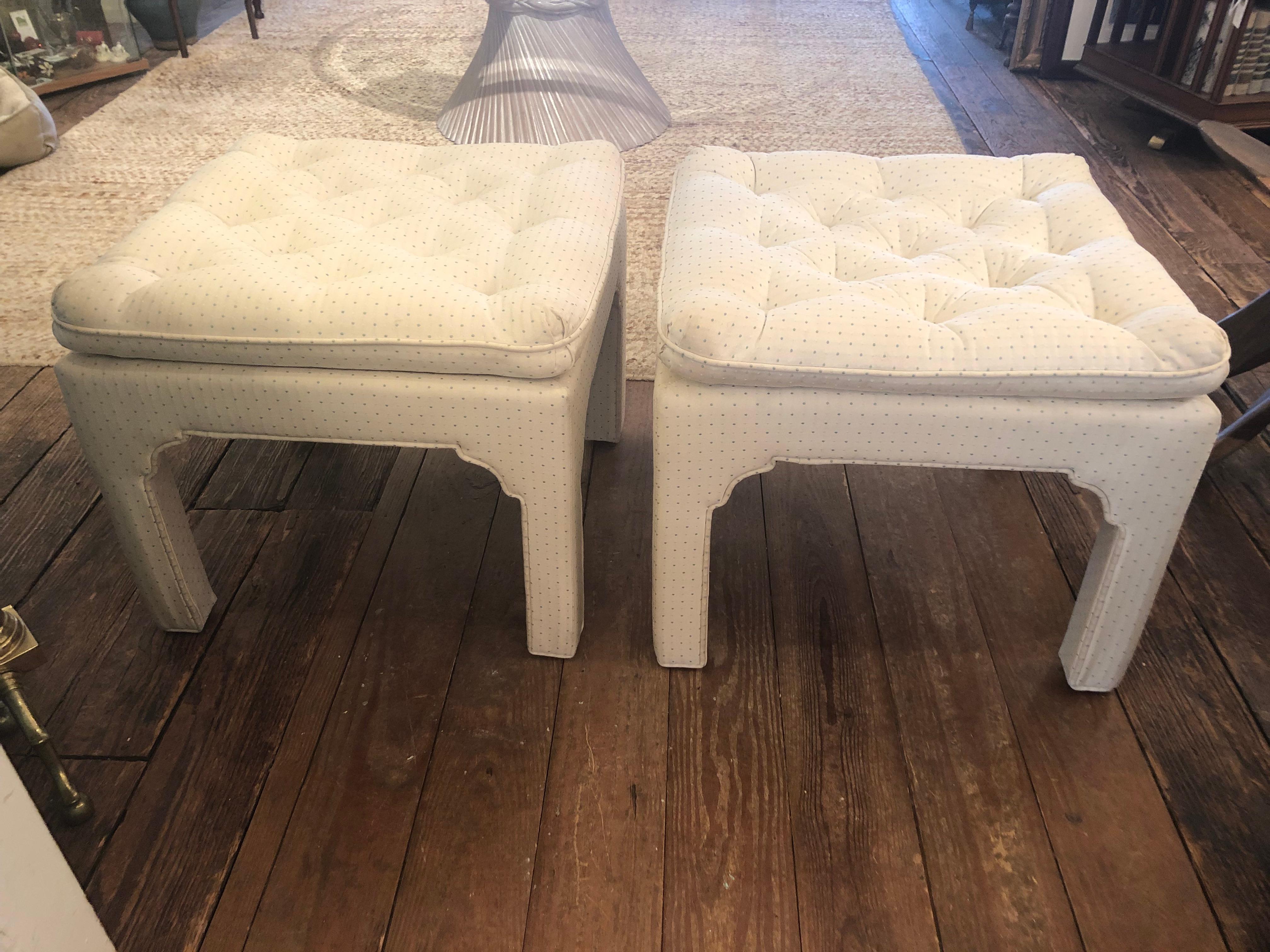 Classic Billy Baldwin style upholstered ottomans having tufted pillow tops and Chinese form legs. Fabric is a neutral off white with dots. 
Recommend professional cleaning.