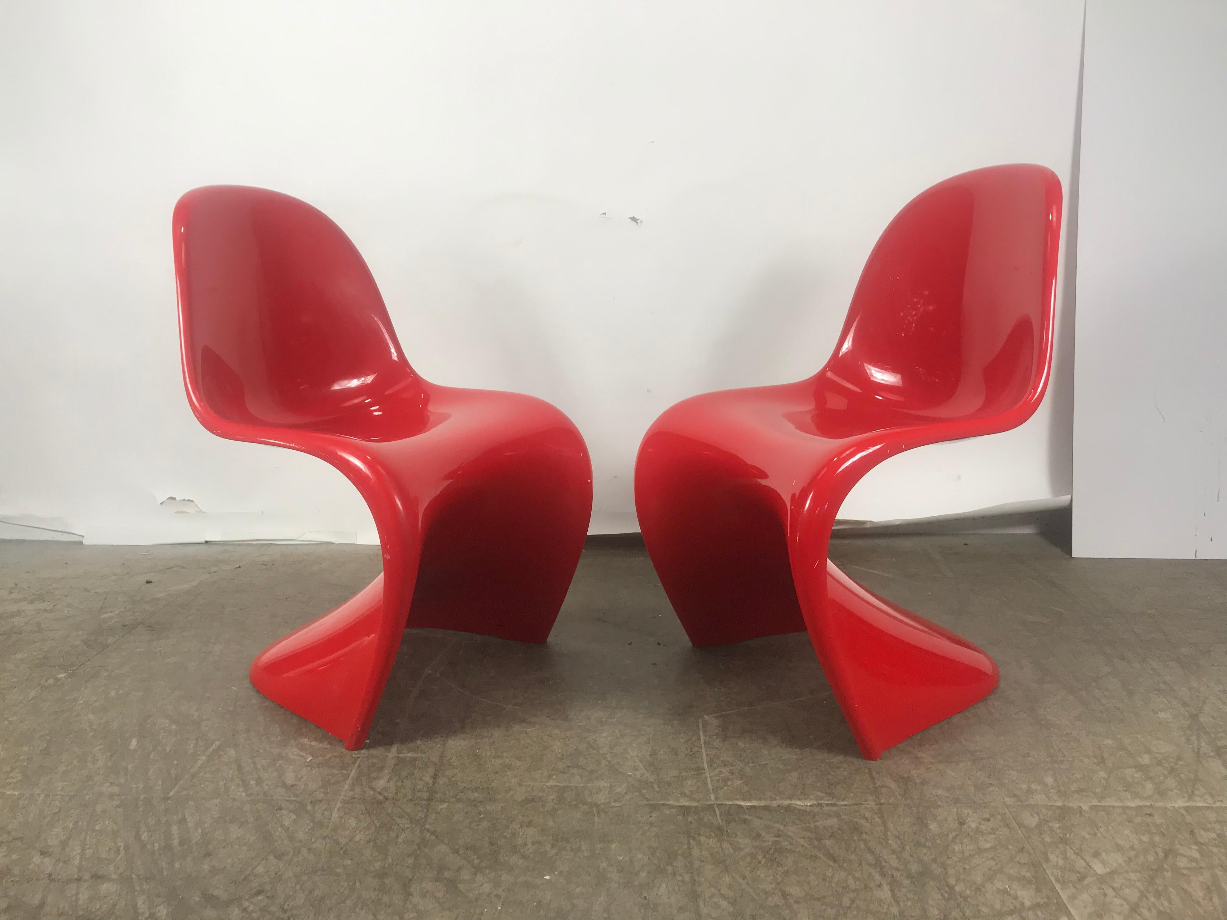 An iconic red stacking chair by influential Danish architect and designer Verner Panton (1926-1998). Designed in 1958, this cantilevered, stackable chair is the first single-form, injection-molded plastic chair ever produced. A masterpiece of design