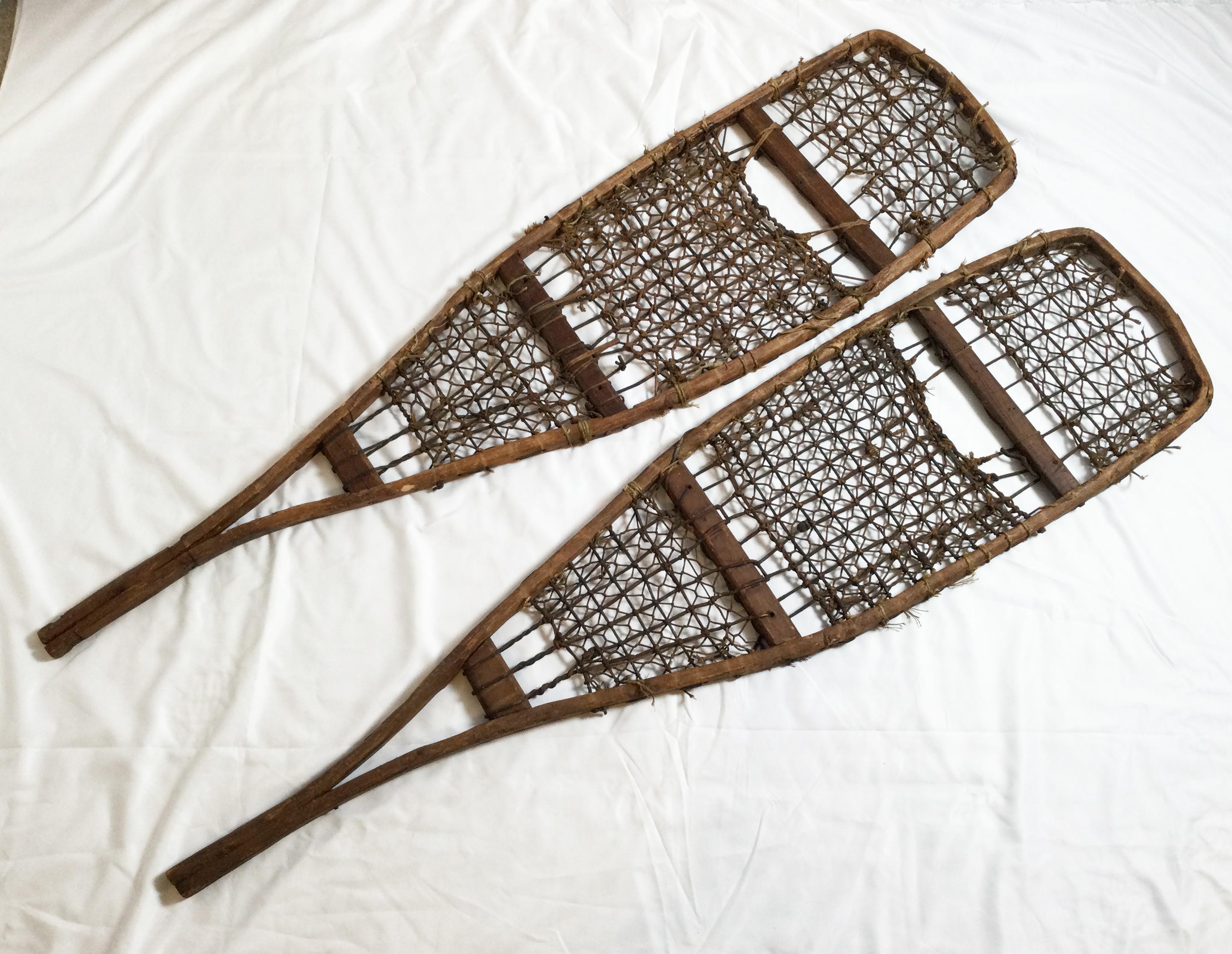 These well-worn truly Classic snowshoes have wonderful character! The handcrafted pair shows off an intricate weave, the wood frame measures 10” at the bottom and 12” at its widest point. Although these are now “retired” their original purpose and