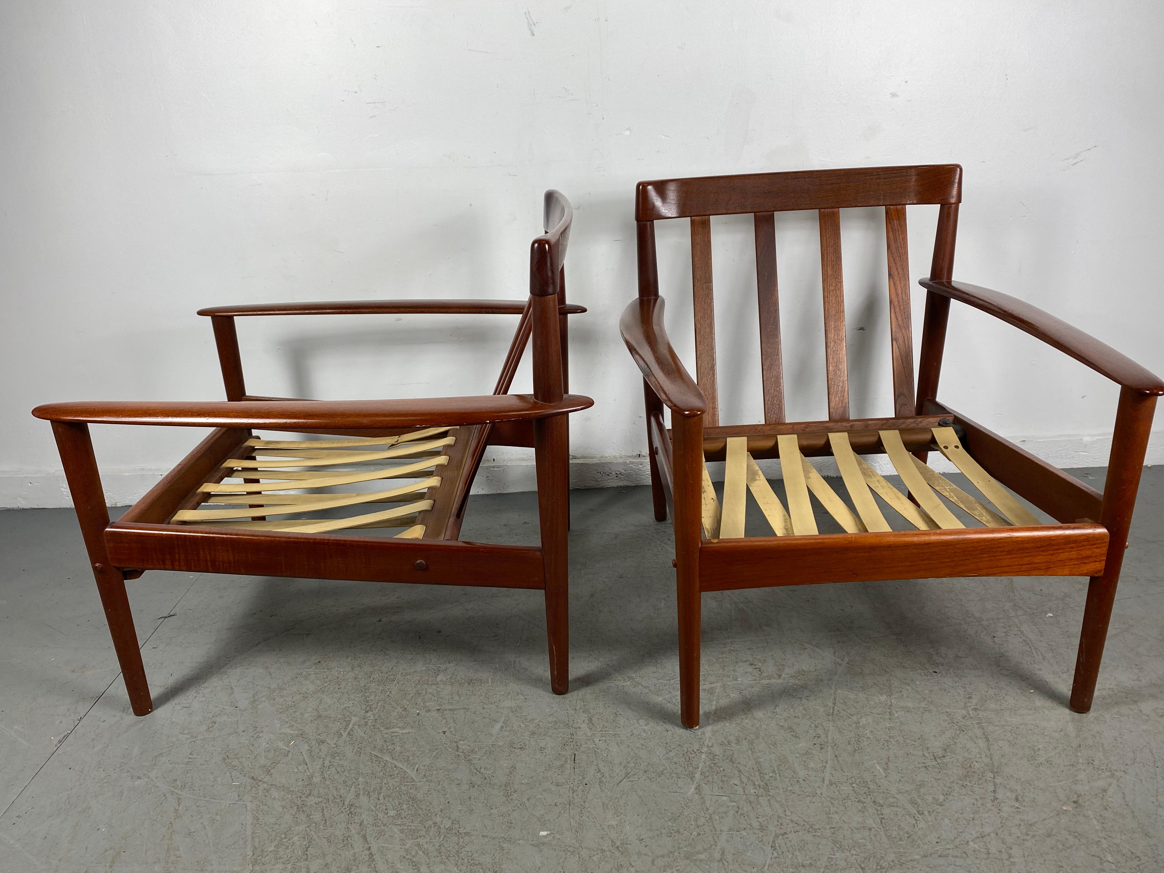 Classic pair teak easy chairs designed by Grete Jalk for P. Jeppesens made in Denmark,, Frames in wonderful original condition,, Retain original strapping,, Original seat and back cushions have been replaced..Superior quality and