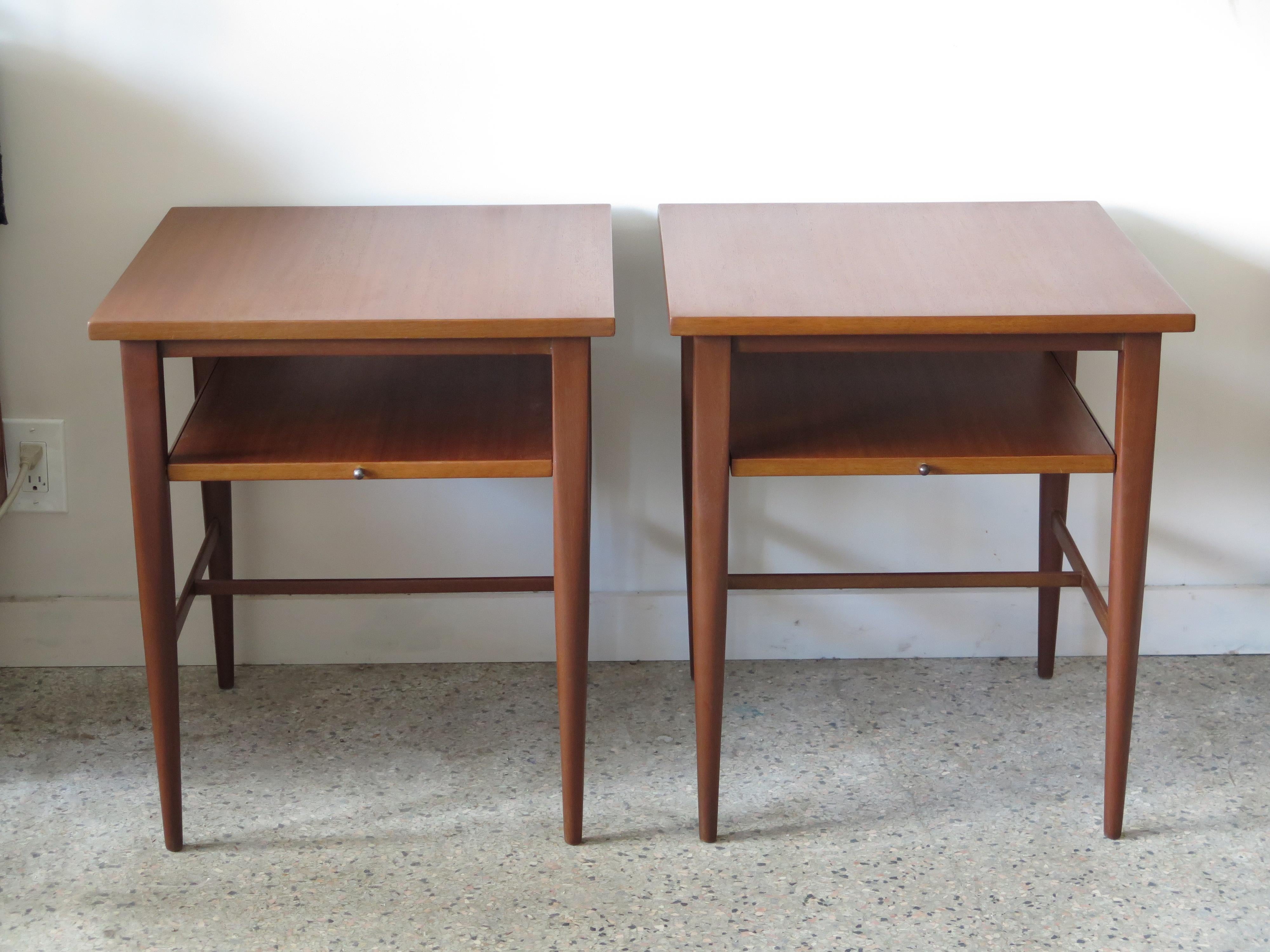 A pair of Paul McCobb for Calvin end tables-could also be night stands, with pull out tray. Very nice restored condition. Both signed underneath.