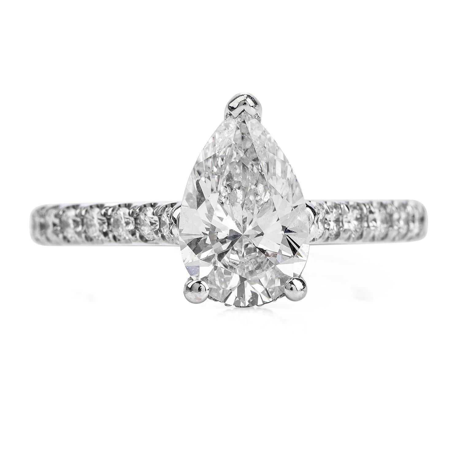 This stunning diamond engagement ring is crafted in solid 14k white gold. Displaying a three-prong set GIA certified pear diamond approx. 1.70 carats, D color,  VS2 clarity. Embellished by a pave set diamond on the shank and under